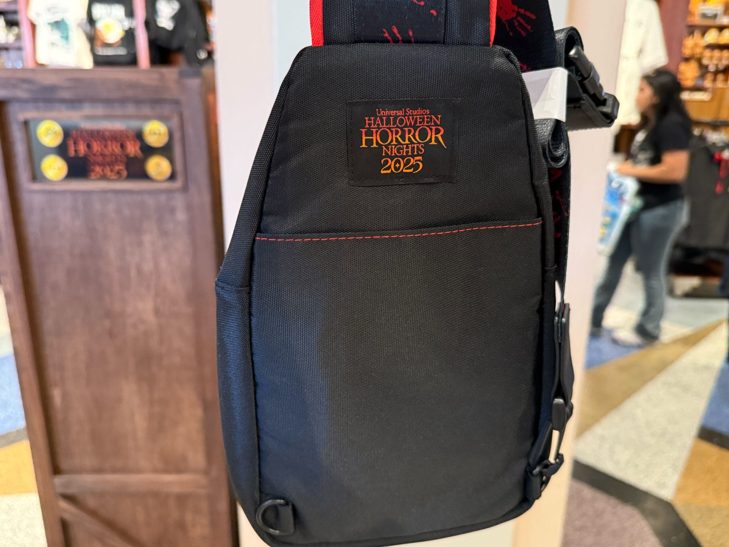 A black sling bag featuring "Halloween Horror Nights 2023" embroidery—a must-have Universal Studios Hollywood collectible.