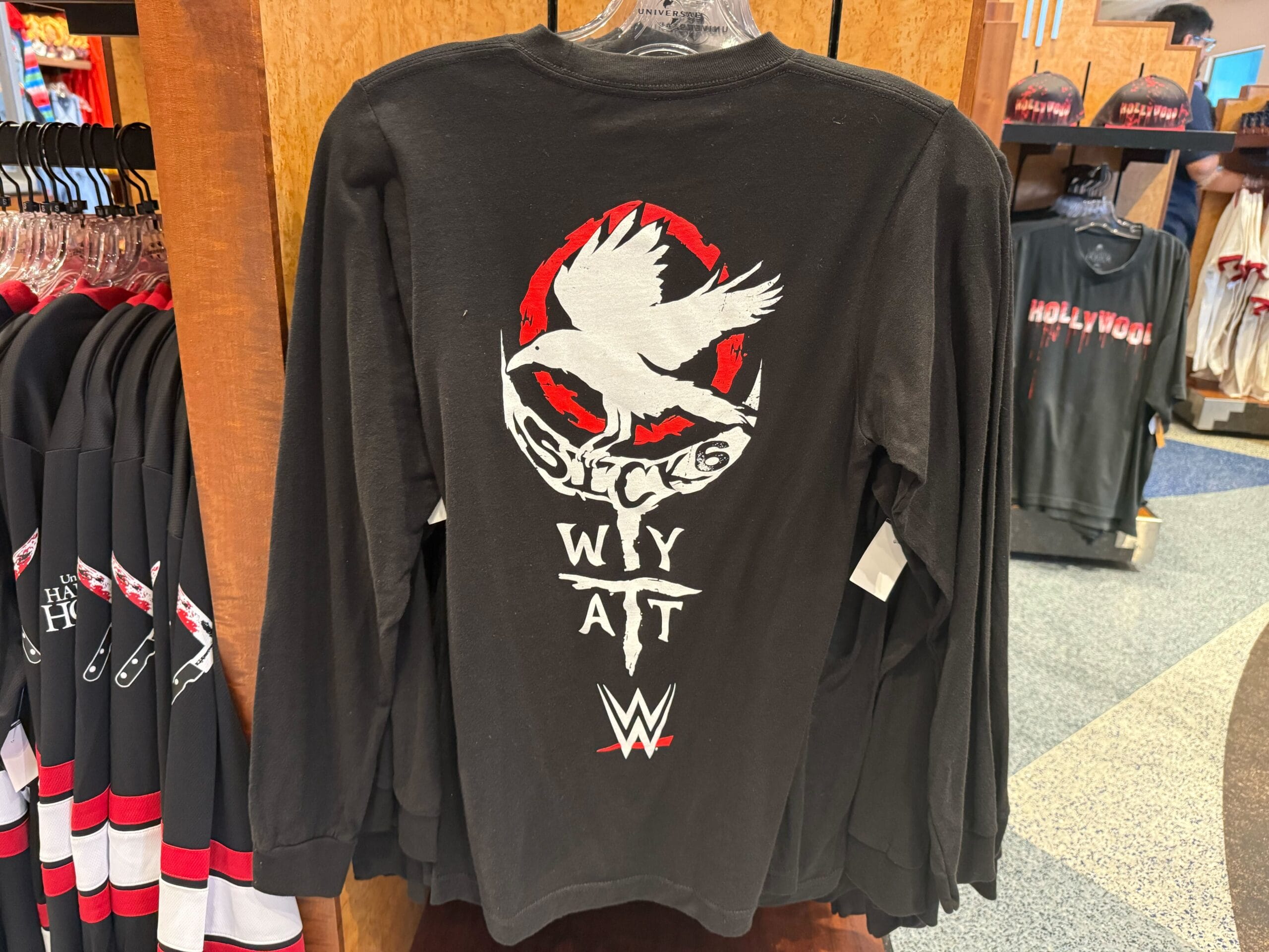 Black long-sleeve shirt with a white bird, red circle, and "Sucks WyatT"—perfect for Universal Studios Hollywood fans.