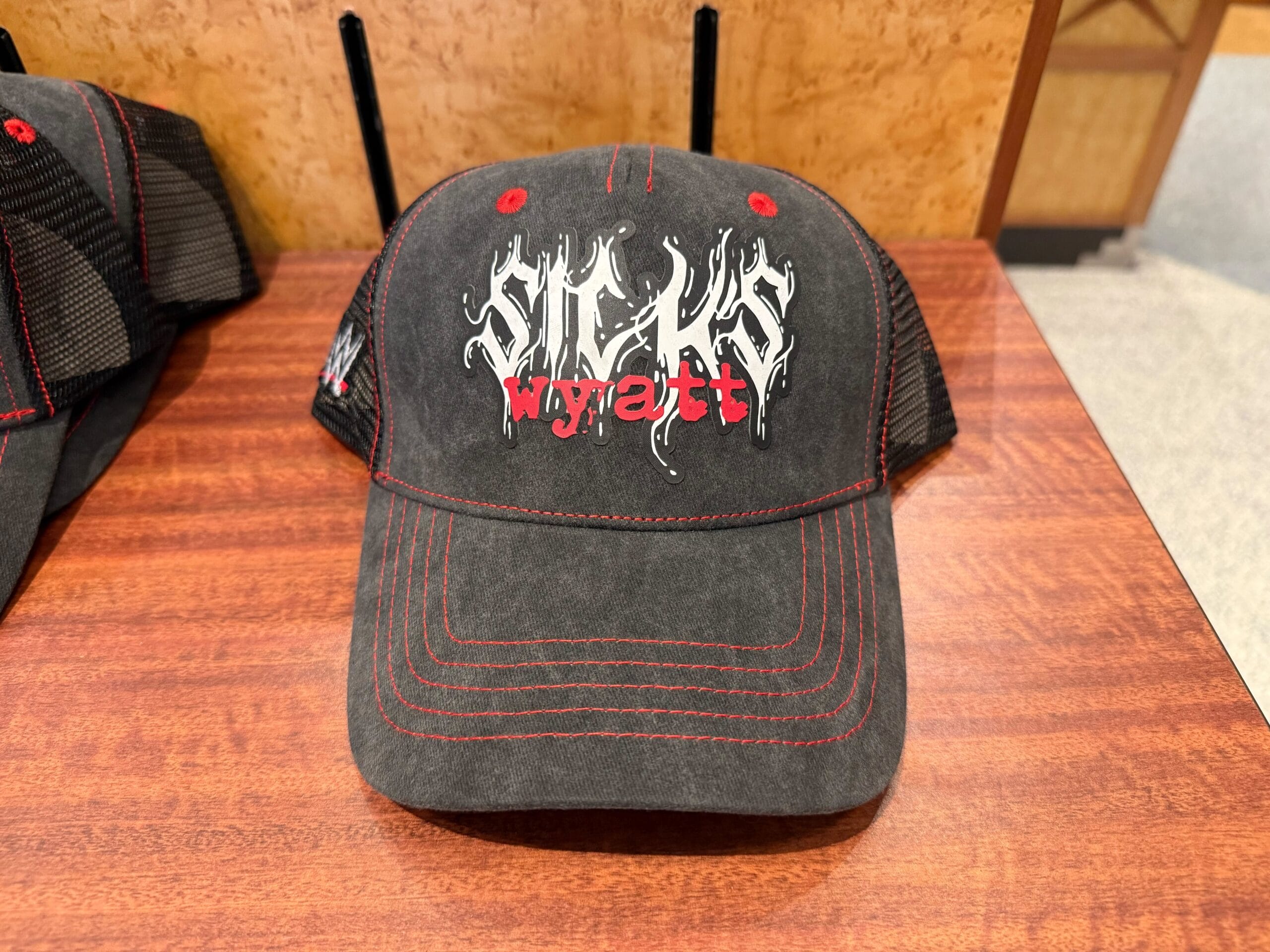 A black baseball cap with "SWAGS" and "Wyatt" in bold, Halloween Horror Nights Merchandise-inspired text.