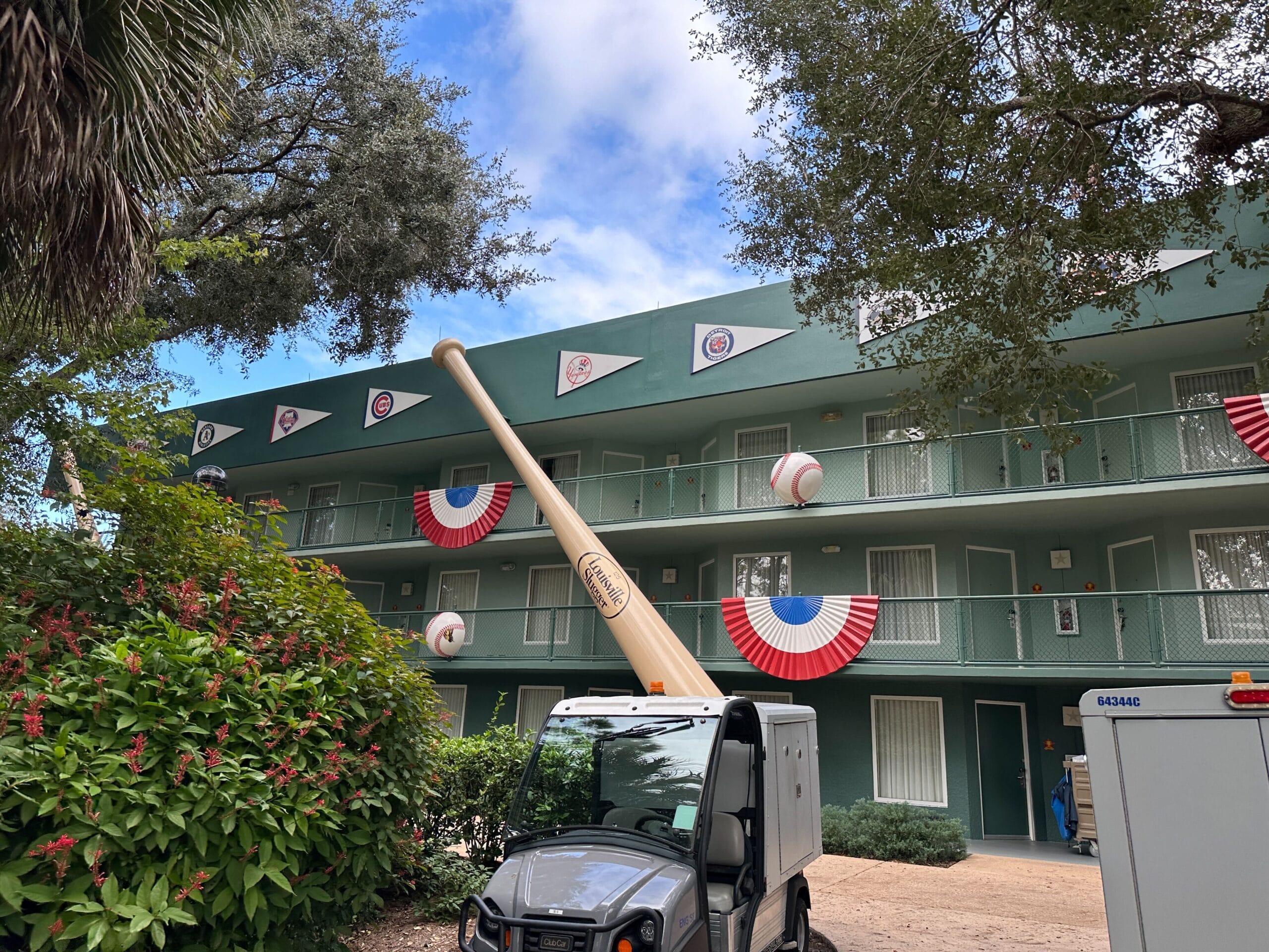 A large bat and baseballs decorate the exterior of Disney All-Star Sports Resort.