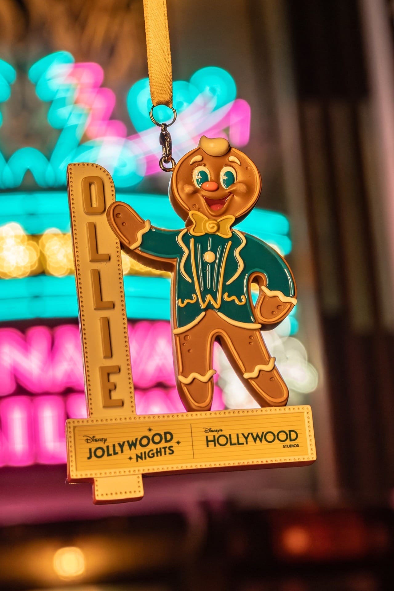 A festive Ollie the Gingerbread Man ornament in a suit at Disney Jollywood Nights, part of 2025 merchandise.
