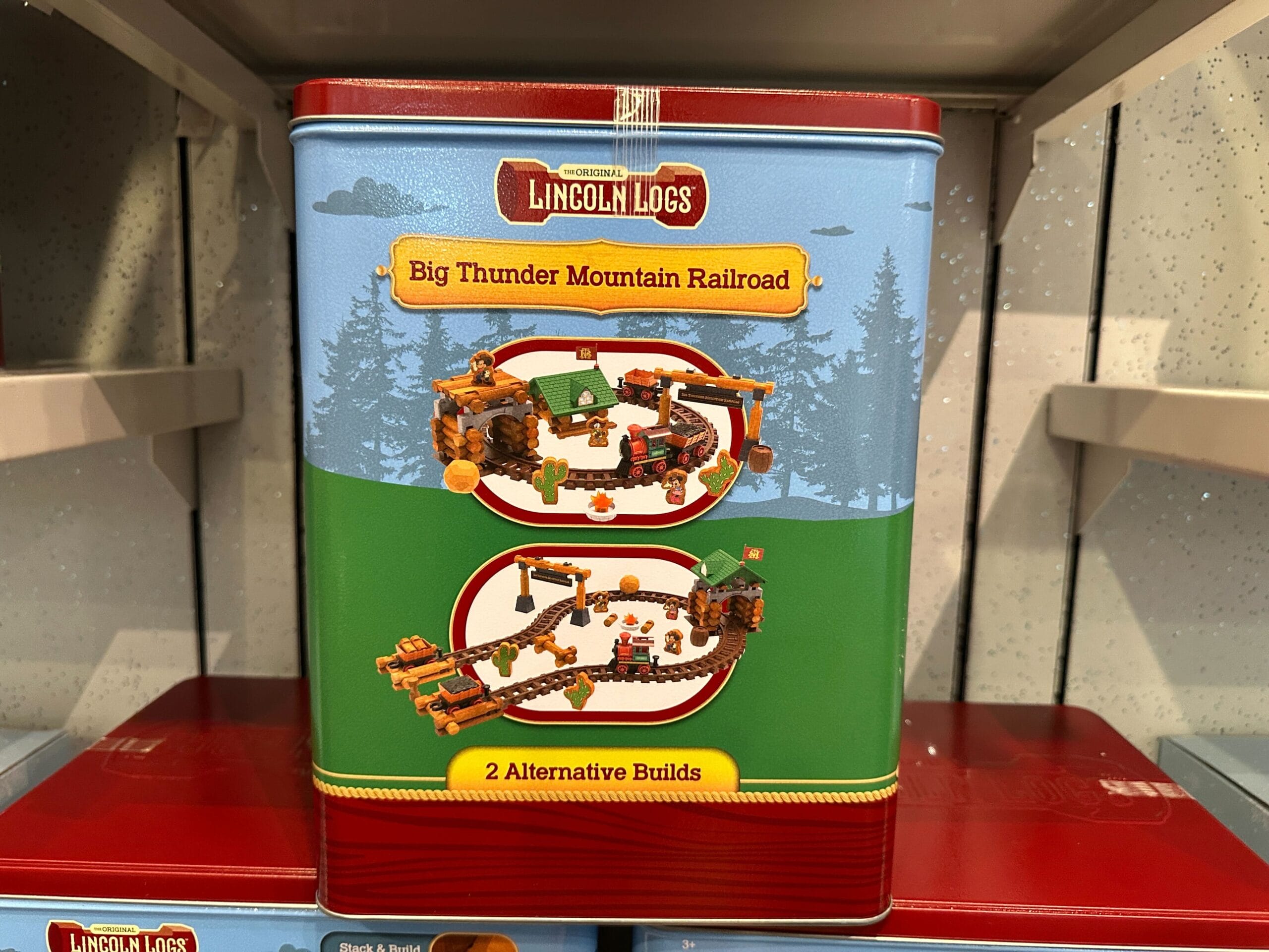 Lincoln Logs Big Thunder Mountain Railroad tin featuring images of two possible train track builds on the front.