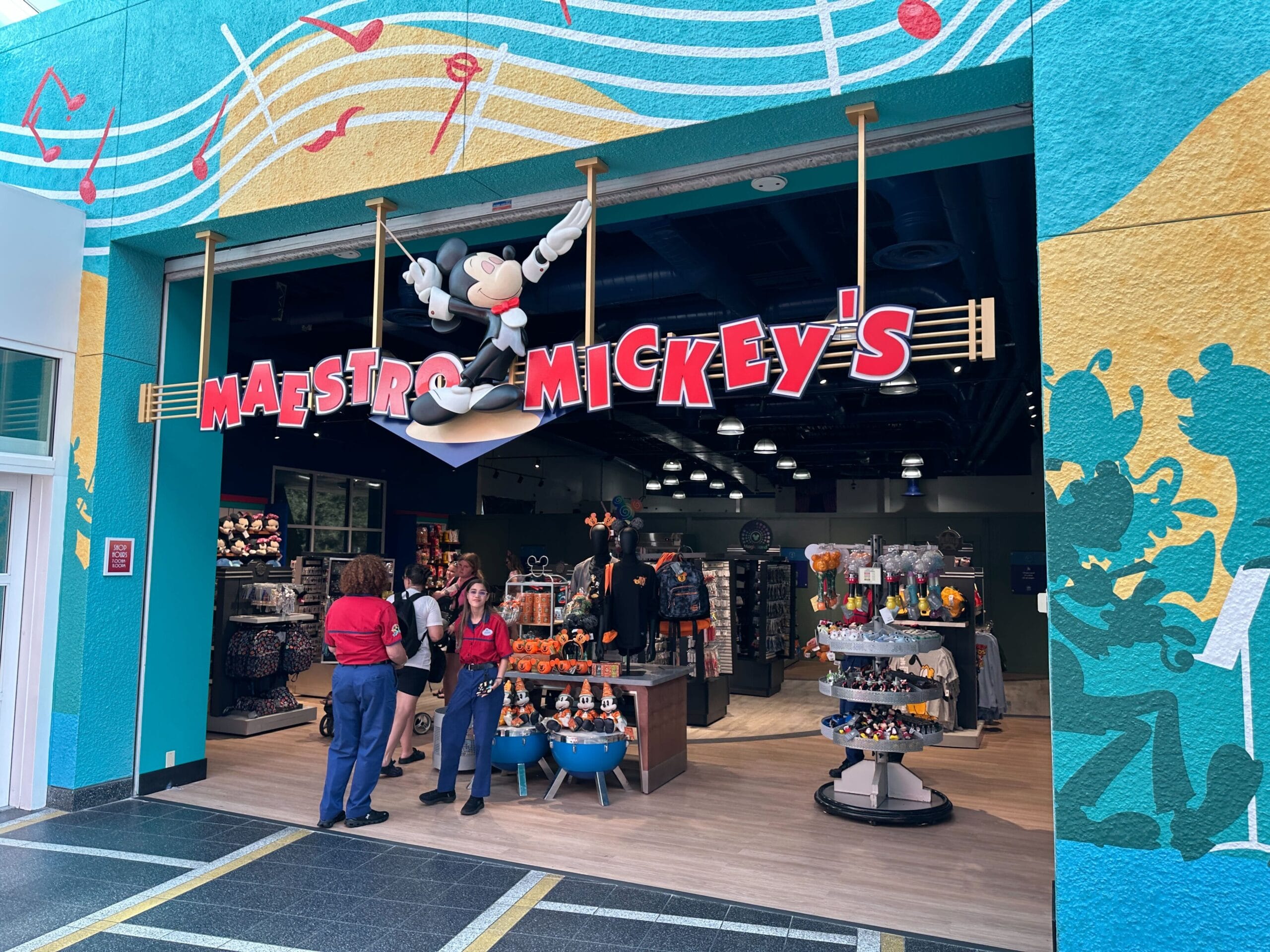 Storefront of Maestro Mickey’s with a Maestro Mickey figure above the entrance and people standing outside.