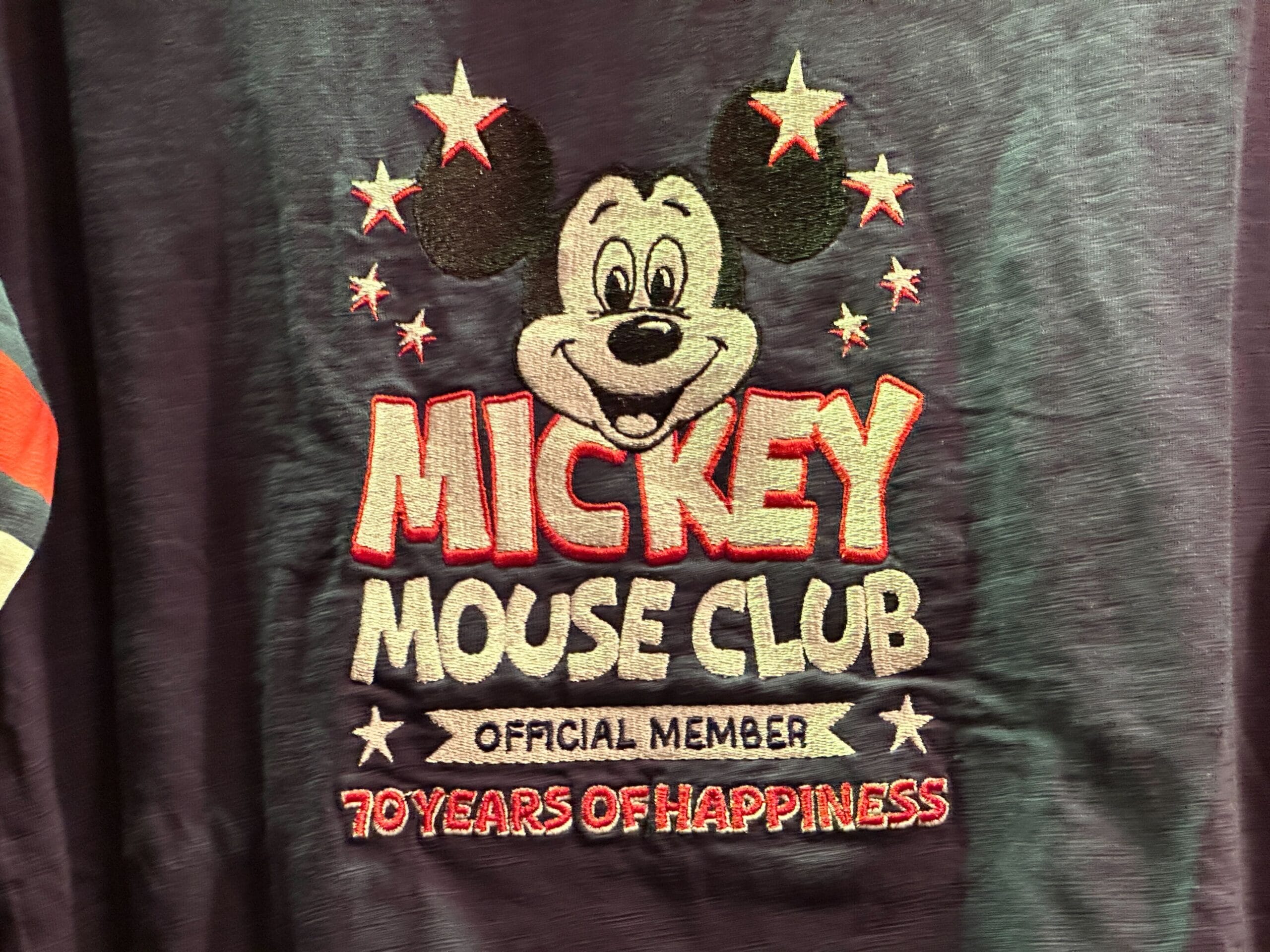 Embroidered Mickey Mouse Club logo with text: "Official Member, 70 Years of Happiness" and stars around Mickey's head.