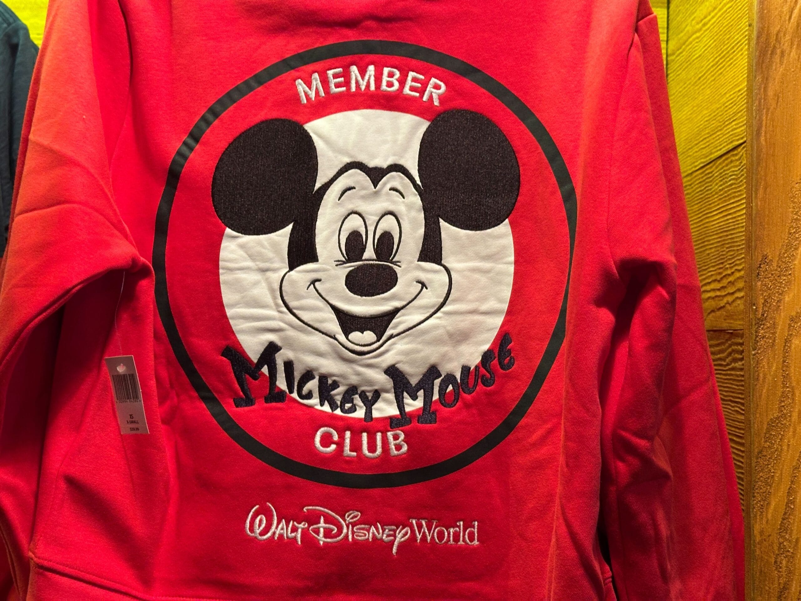Red sweatshirt with a large "Mickey Mouse Club" logo and smiling Mickey Mouse face, reading "Walt Disney World" below.