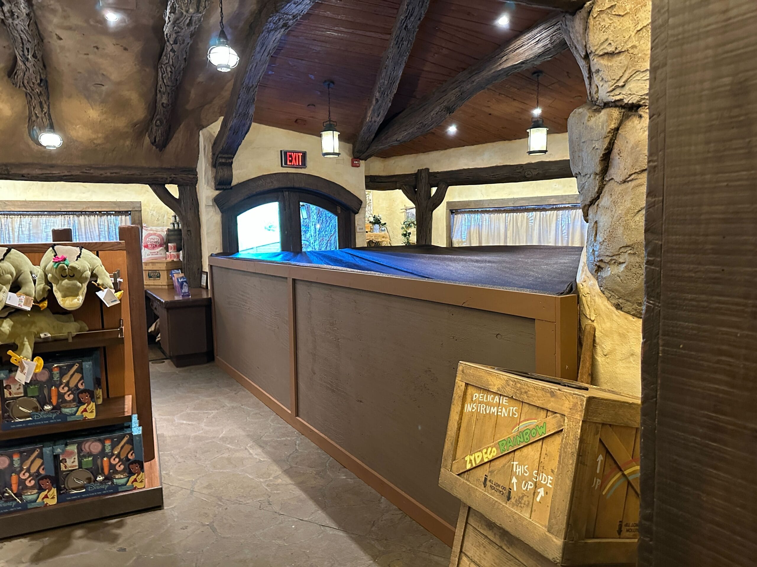 A wooden construction wall blocks part of Critter Co-Op, with plush toys and display shelves nearby.