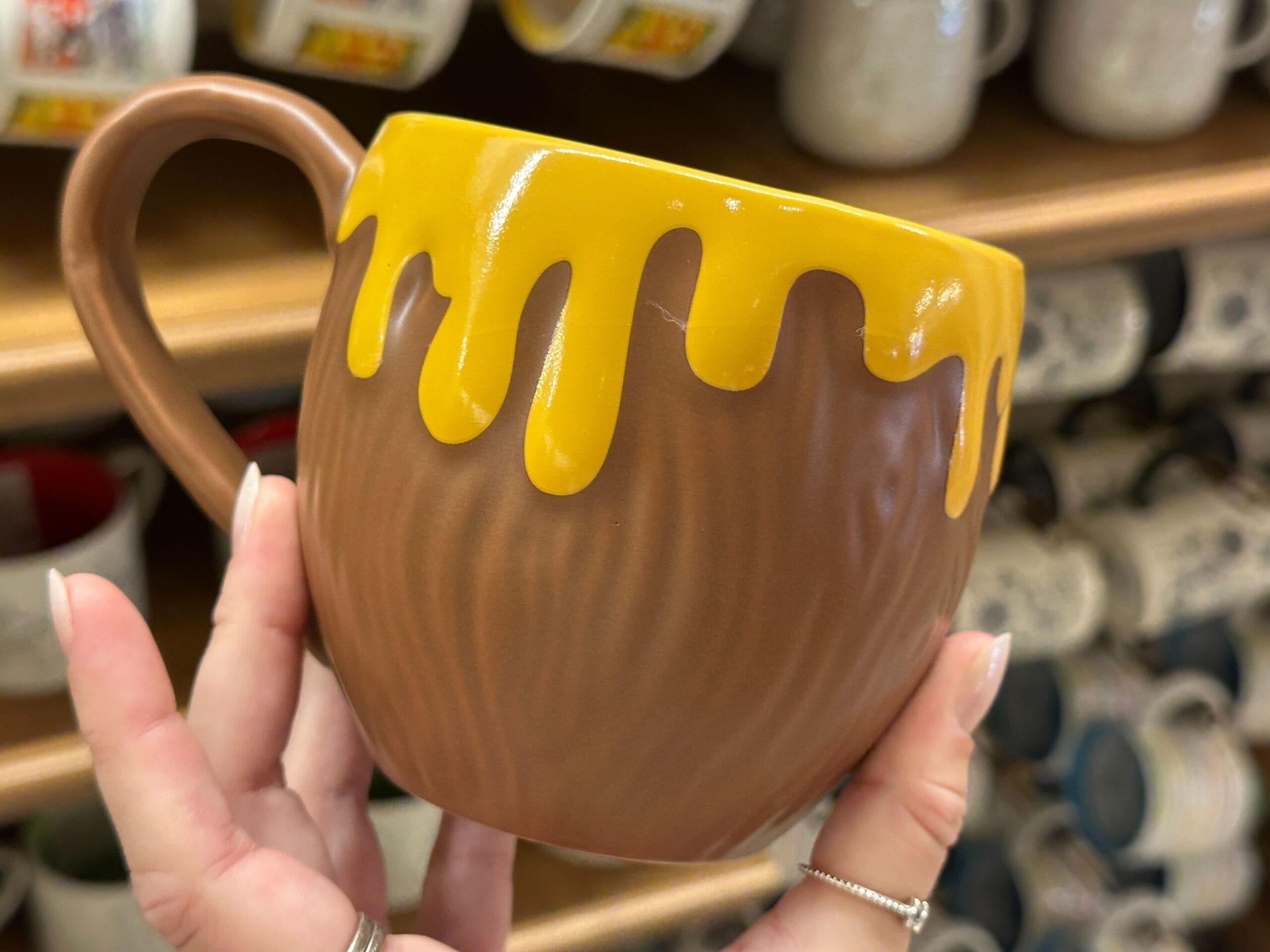 A hand holding a coffee mug