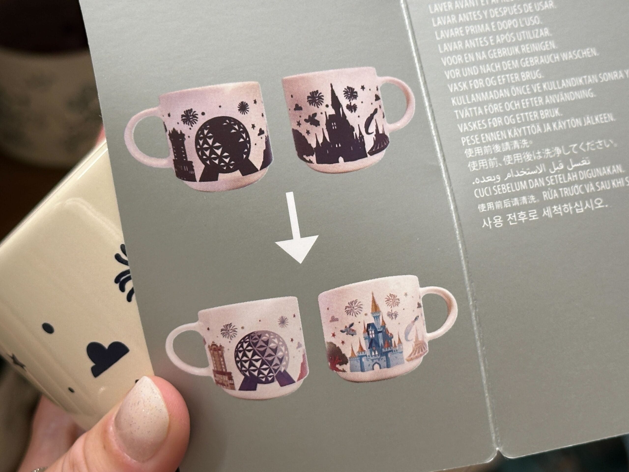 Two illustrated coffee mugs featuring Mickey designs, with heat revealing even more colorful theme park details.