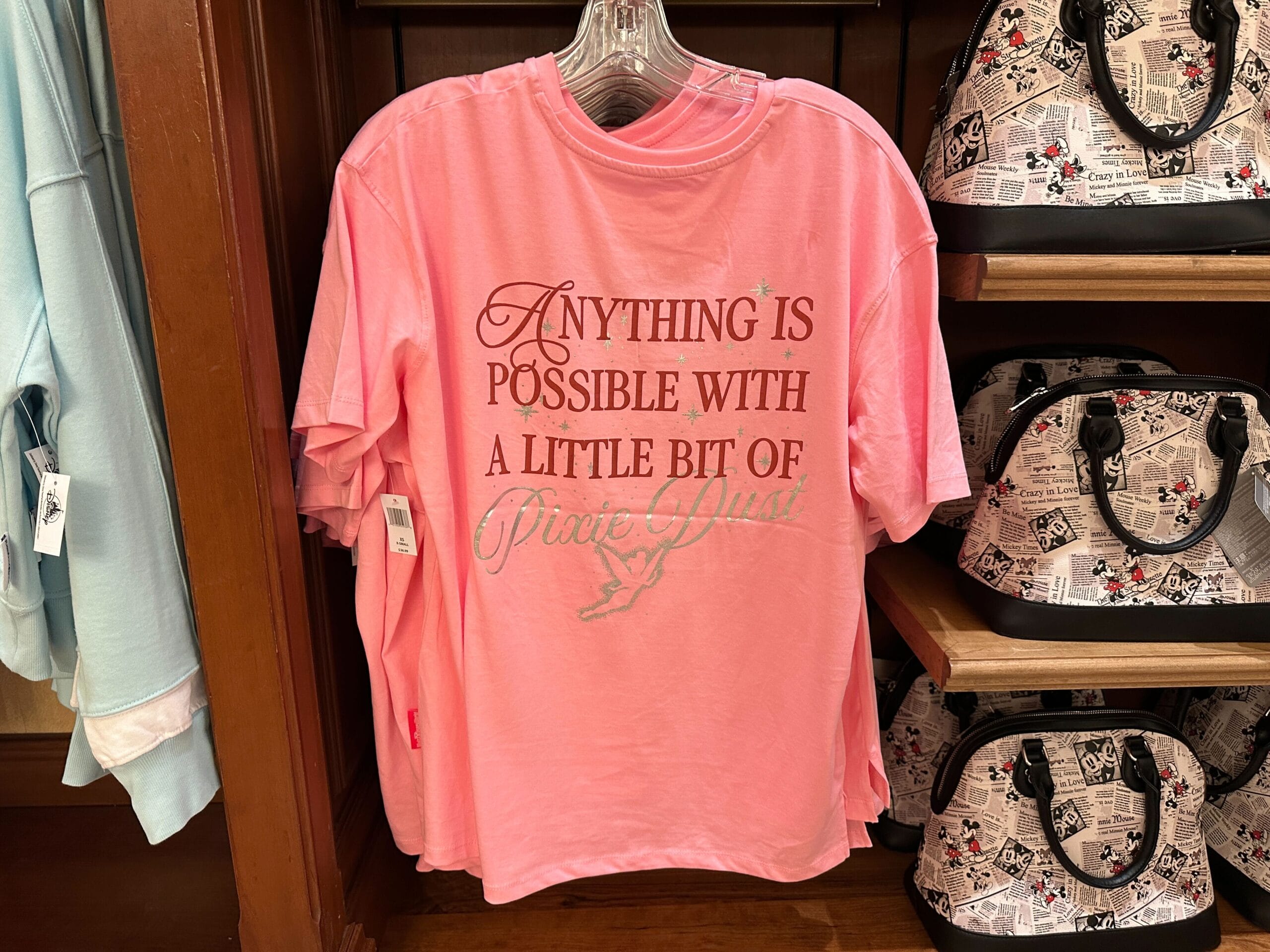 Pink T-shirt on display with text: "Anything is possible with a little bit of pixie dust.