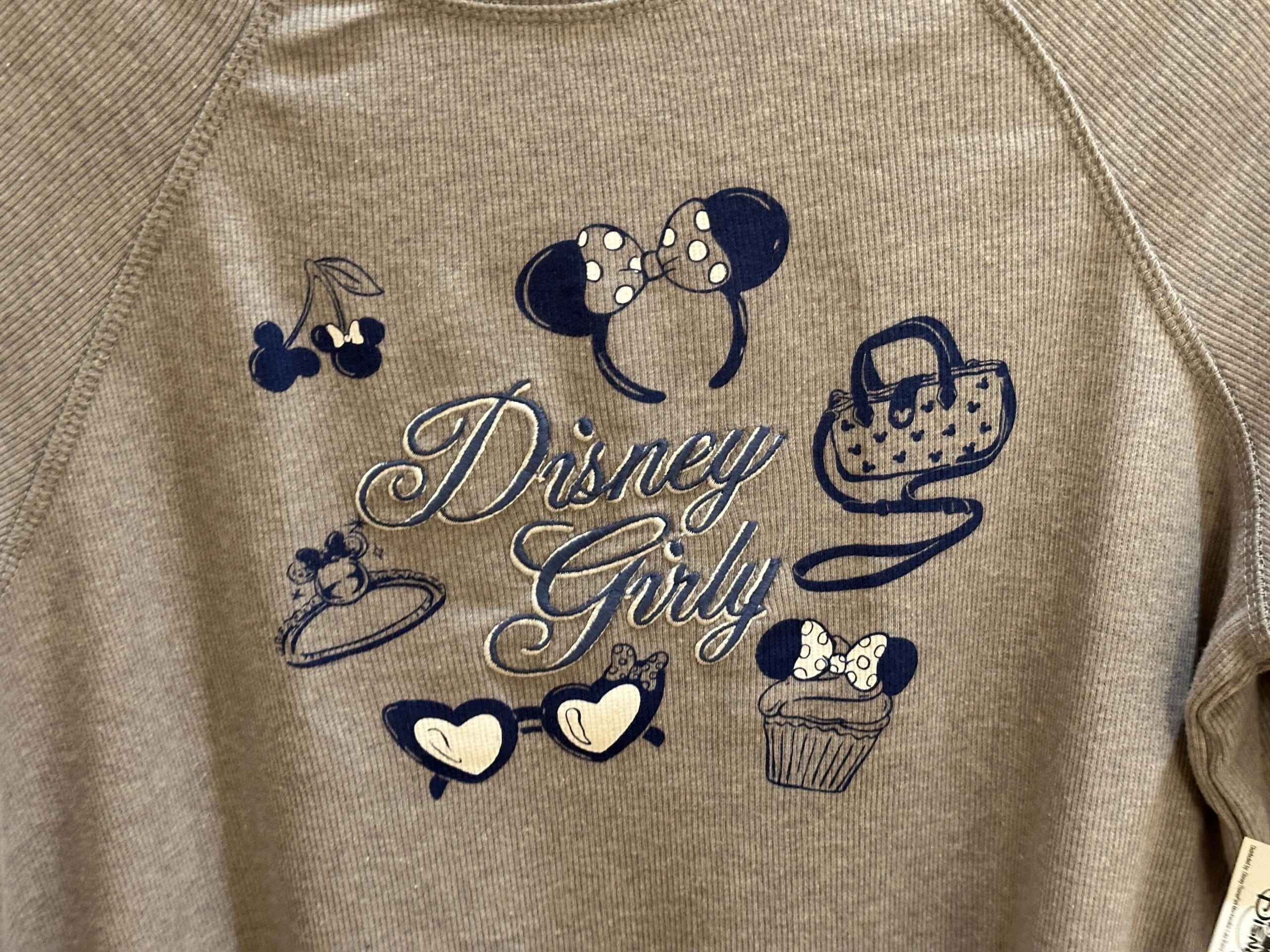 Beige shirt with "Disney Girly," Minnie bows, cherries, a purse, heart glasses, and a cupcake graphic.