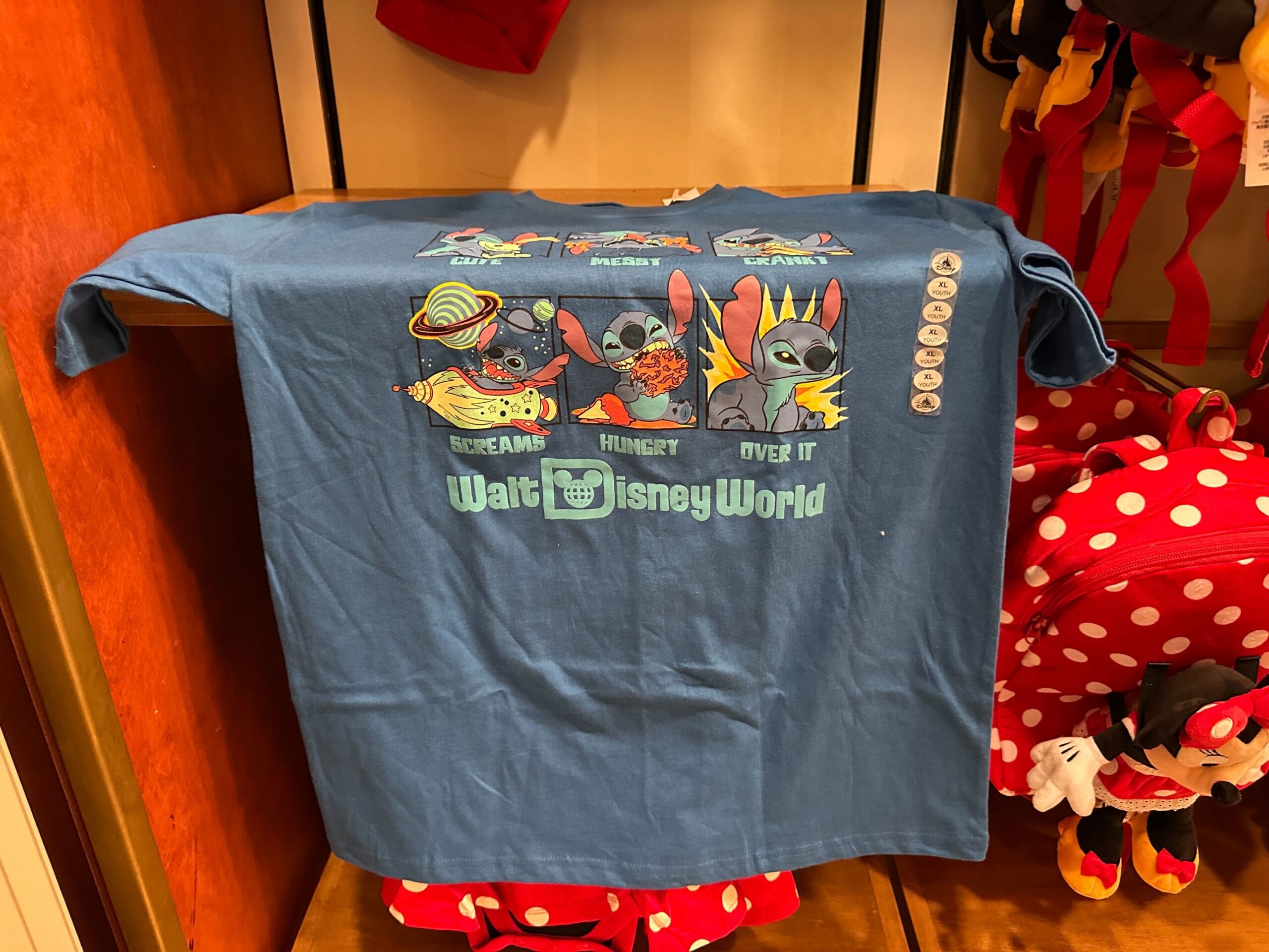 Blue Walt Disney World t-shirt with Stitch in four poses and text: “Screams, Hungry, Over It.”