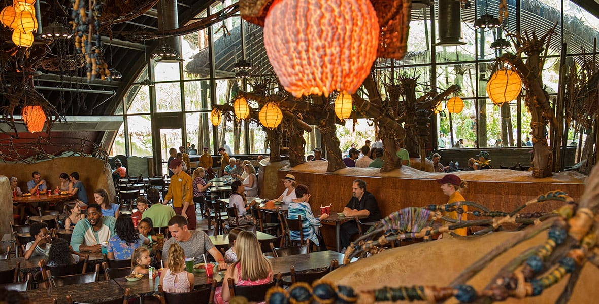 The interior of Satu'li Canteen, filled with diners, showcases Avatar nature-inspired decor within Pandora - The World of Avatar at Disney's Animal Kingdom.