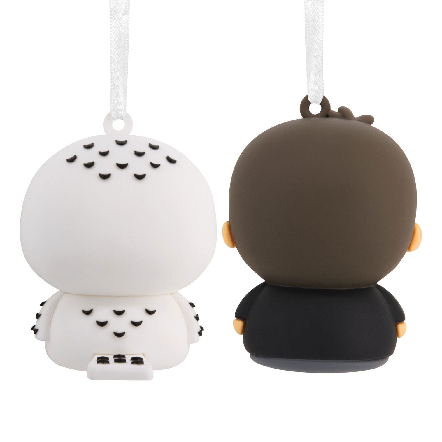 Two Disney-style Hallmark Ornaments from behind: one white with black spots, the other with dark brown hair and a black outfit.