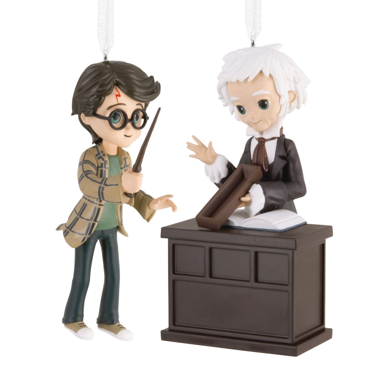 Figurines as Hallmark ornaments show a boy with glasses and wand facing an older man, evoking magical movie magic