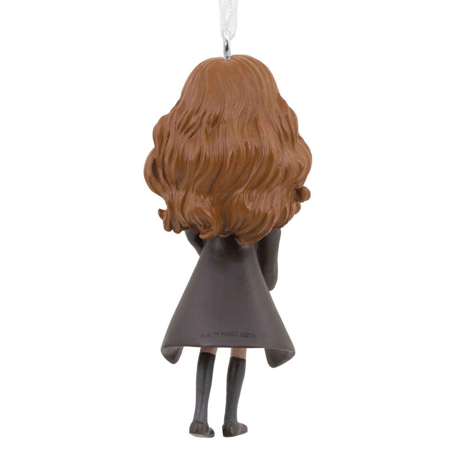 A Hallmark Ornament of a girl with wavy brown hair in a black coat, seen from the back