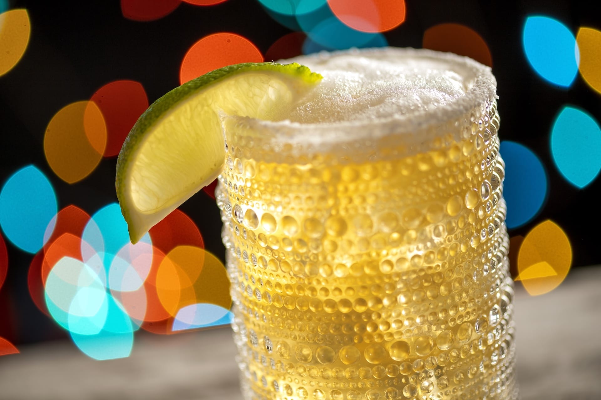 A chilled, fizzy beer topped with a lime wedge, ideal for raising a glass to new offerings at Disney Jollywood Nights 2025.