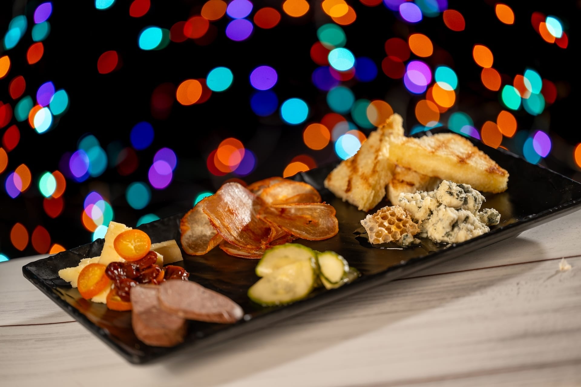 A festive platter of cheeses, meats, and fruits showcases new offerings at Disney Jollywood Nights 2025 in the parks.