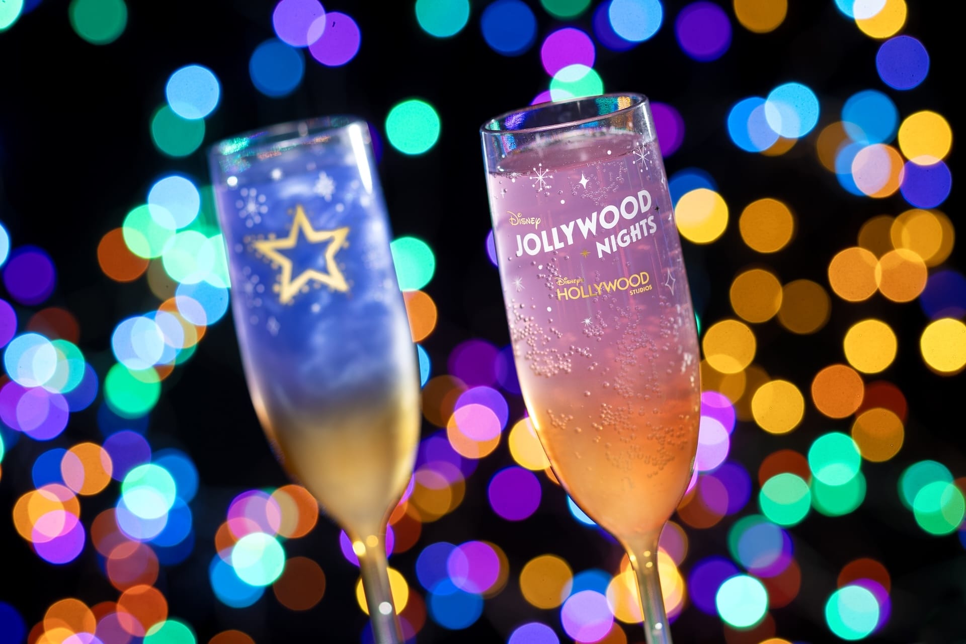 Glittering champagne flutes raised for a toast at Disney Jollywood Nights 2025, capturing the park’s festive spirit.
