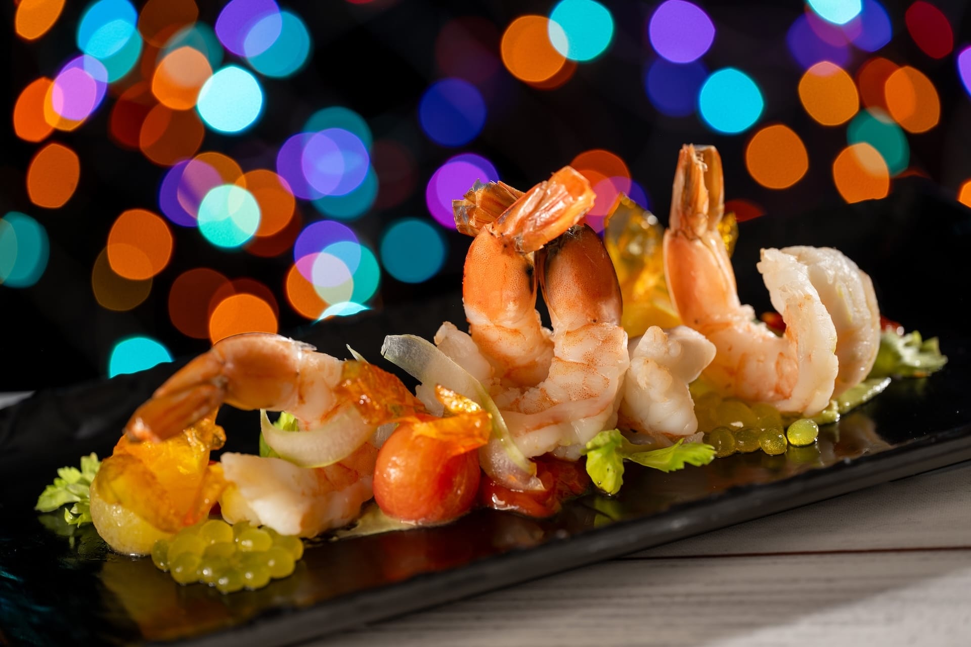 Shrimp cocktail artfully displayed on a black plate, themed after Disney Jollywood Nights 2025 menu at Walt Disney World.