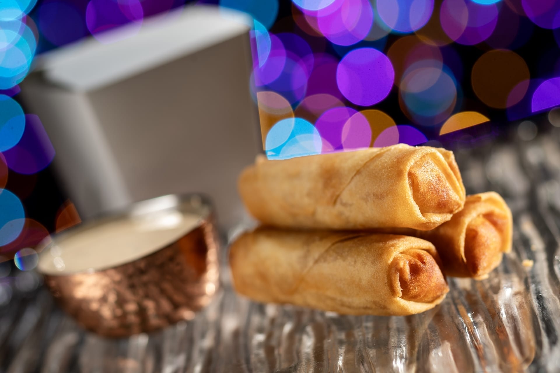 Crispy golden spring rolls with dipping sauce, a 2025 Disney Jollywood Nights treat—no castle like Cinderella’s in sight.