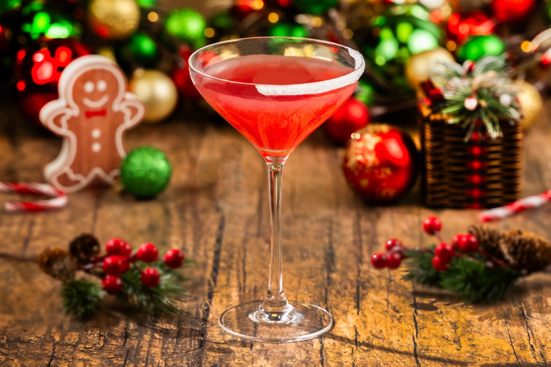 A festive red holiday cocktail at Mickey’s Very Merry Christmas Party, topped with a gingerbread cookie, in Walt Disney World.