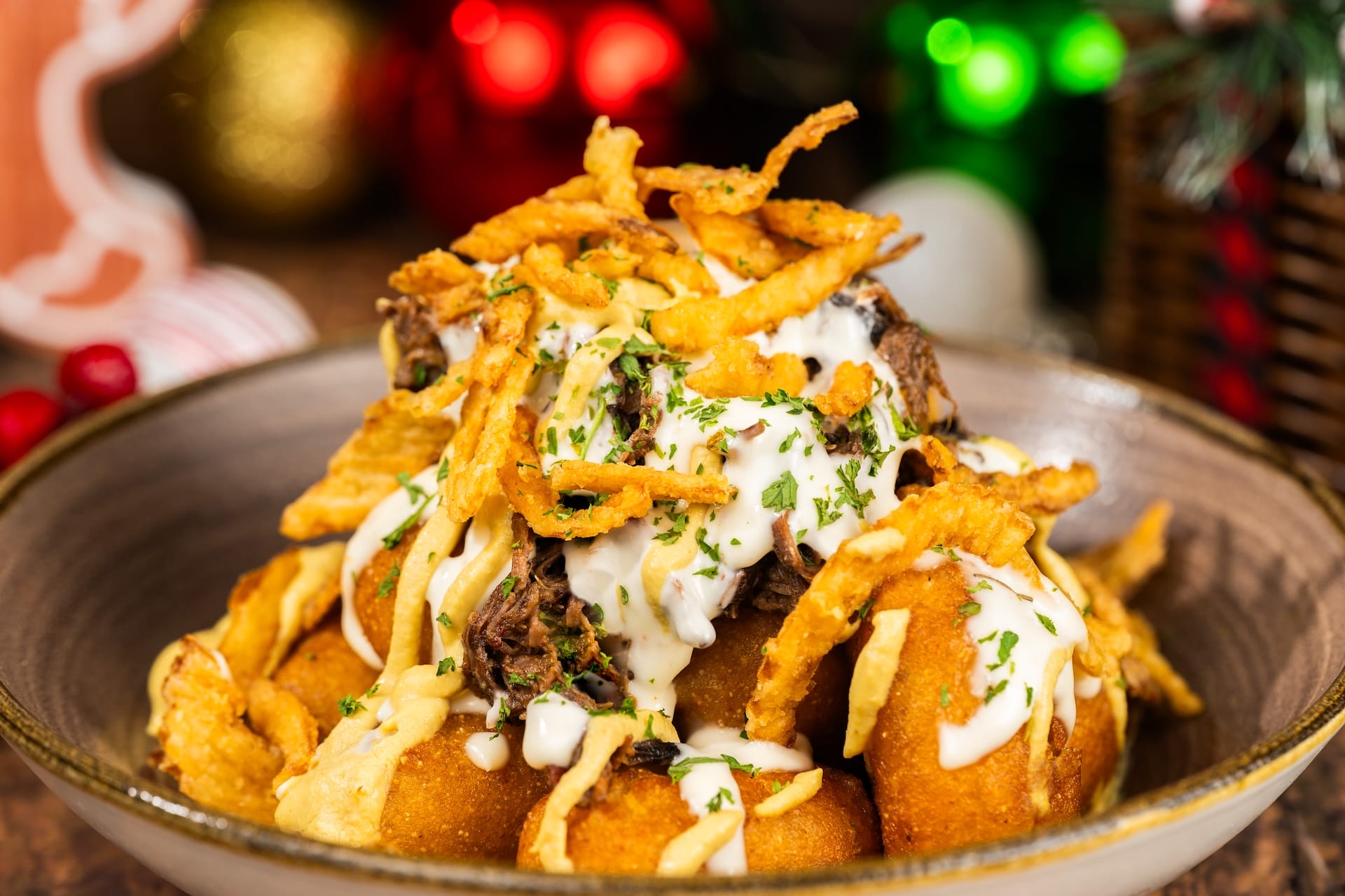 Loaded tater tots with shredded beef, crispy onions, cheese sauce, and herbs at Mickey’s Very Merry Christmas Party in Magic Kingdom.