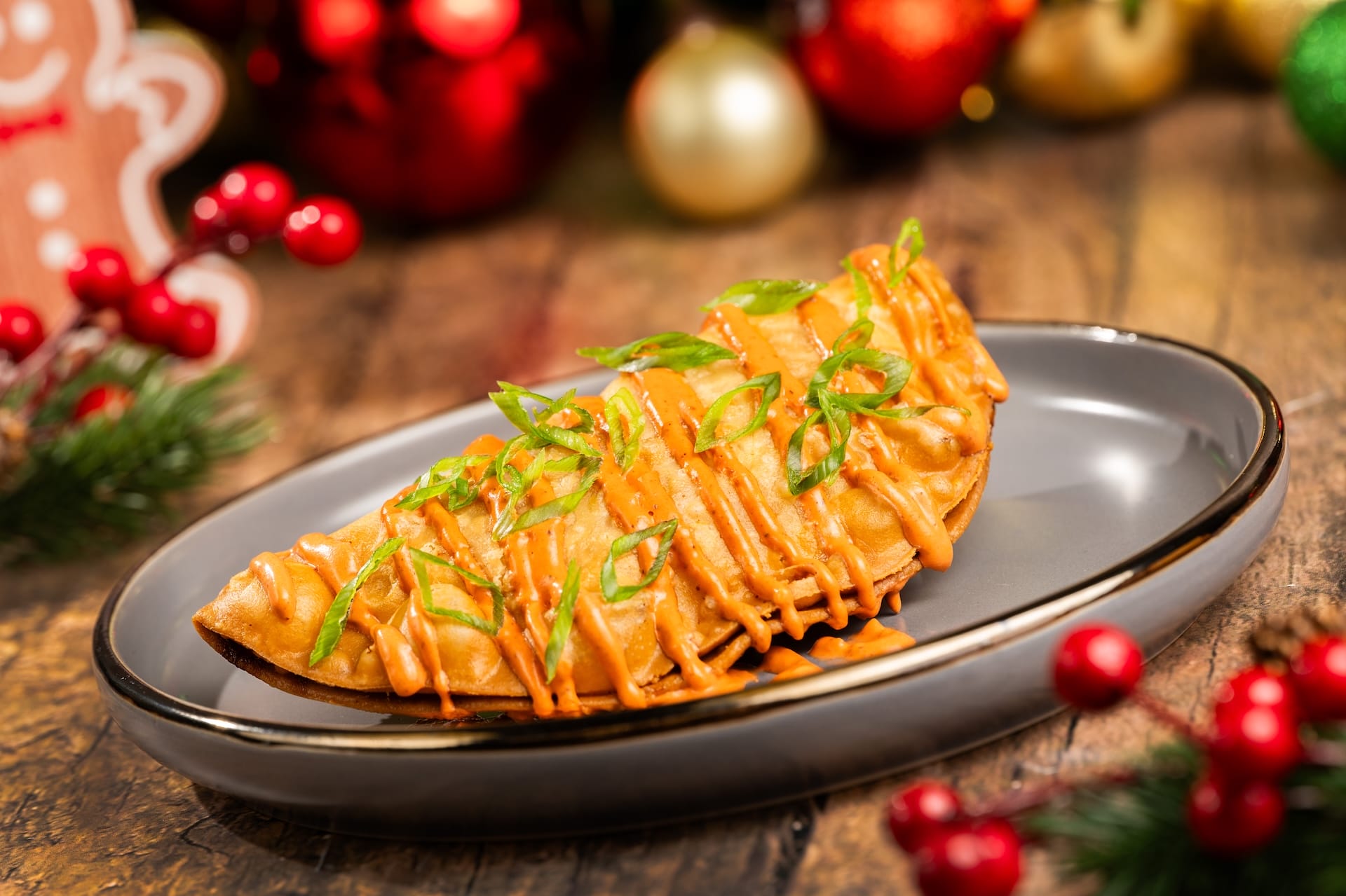 A festive empanada from a Disney park’s 2025 menu, topped with orange sauce and green onions, radiates holiday magic.