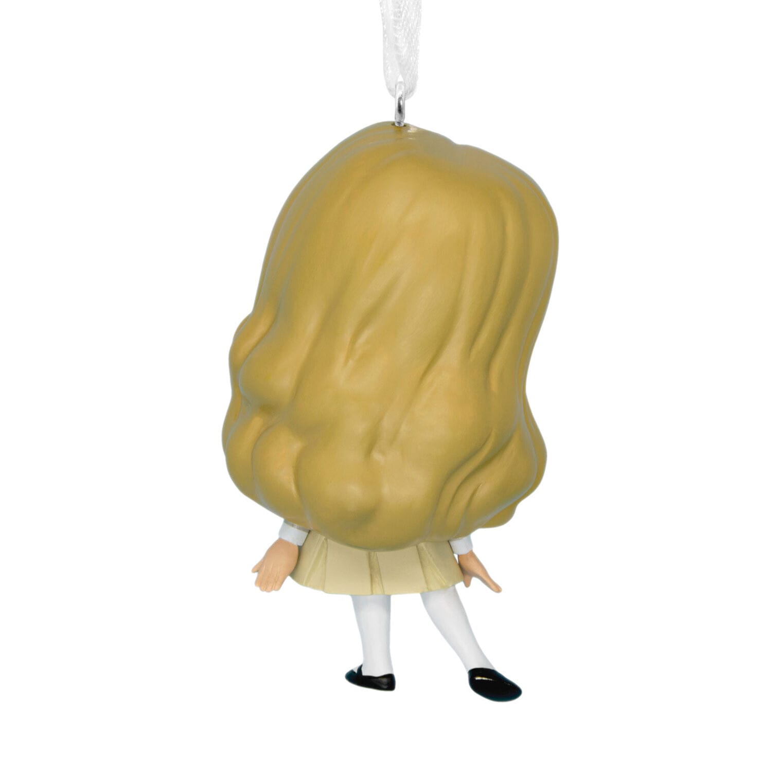 A Hallmark Ornaments figure of a girl with long blonde hair, cream dress, and black shoes