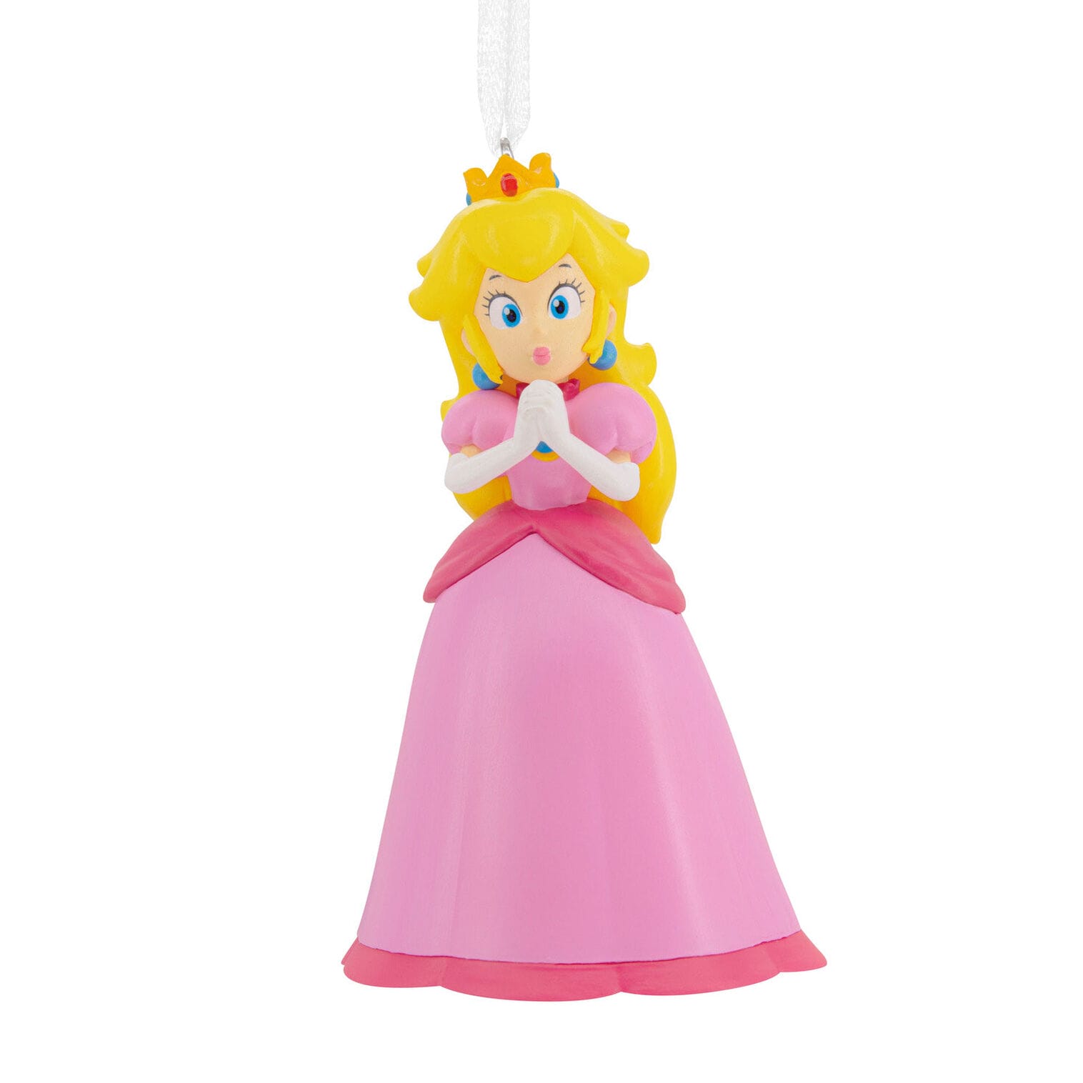 A Princess Peach Hallmark ornament in a pink dress and crown, hands together