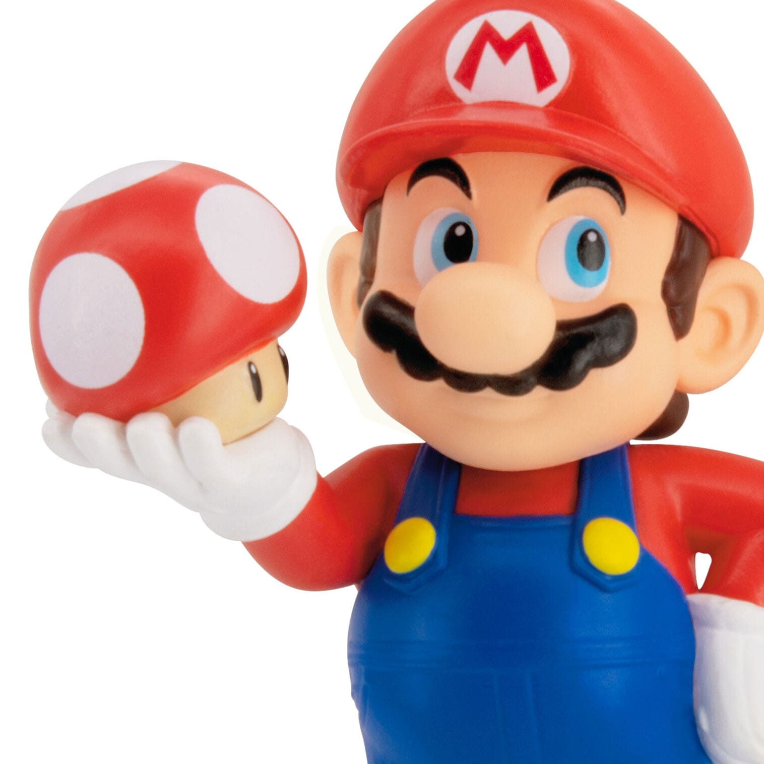 Mario holding a red and white mushroom in his classic outfit