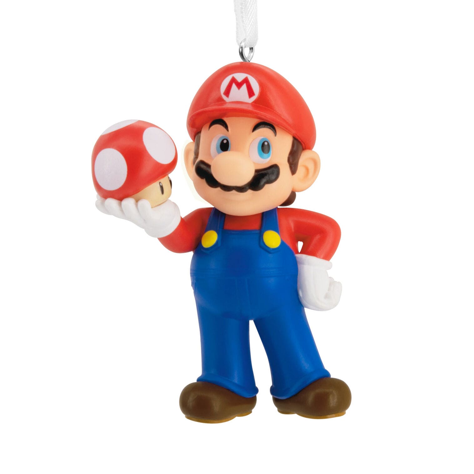 Mario figurine in red hat and blue overalls holds a red and white mushroom