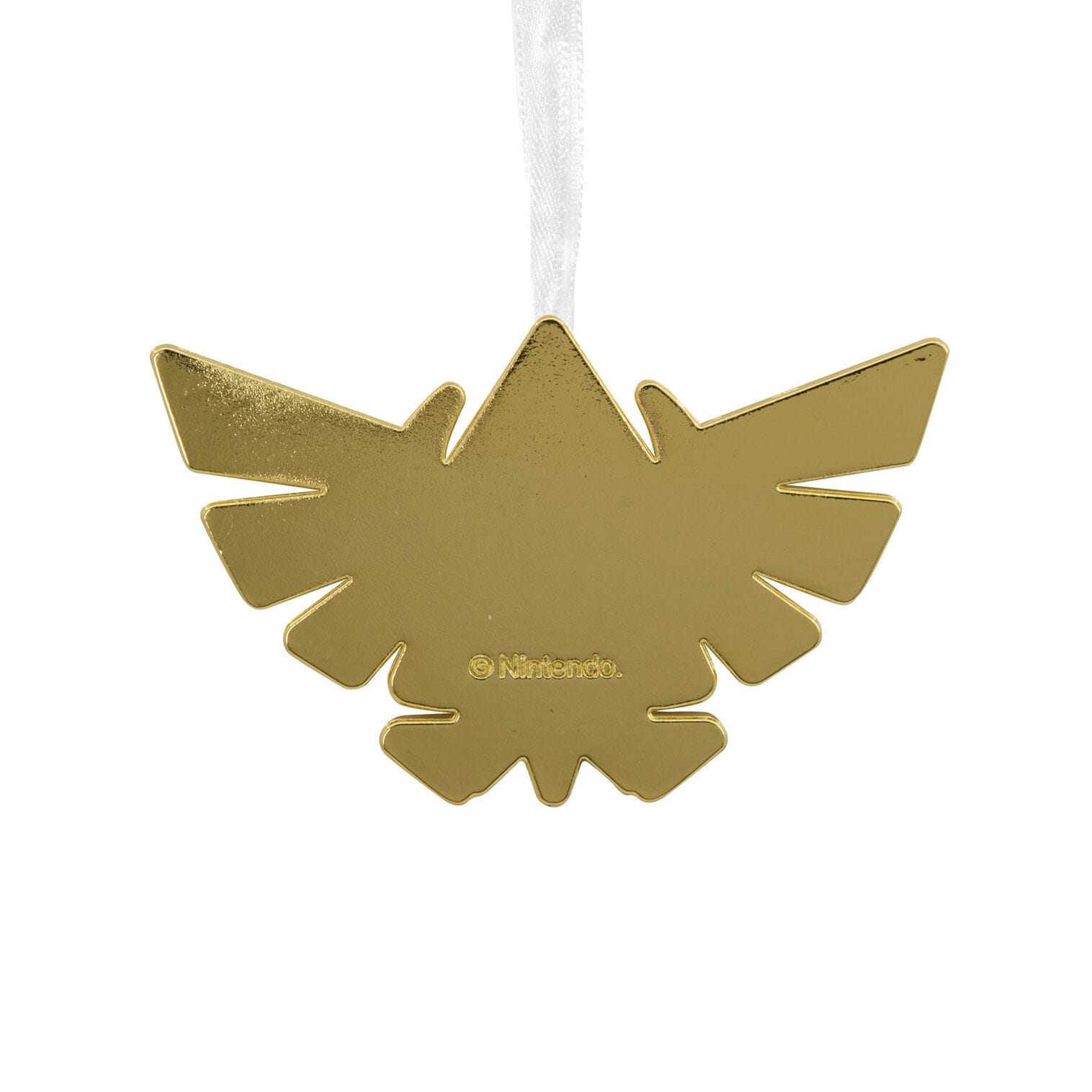 A gold, winged ornament shaped like the Zelda crest hangs from a white ribbon