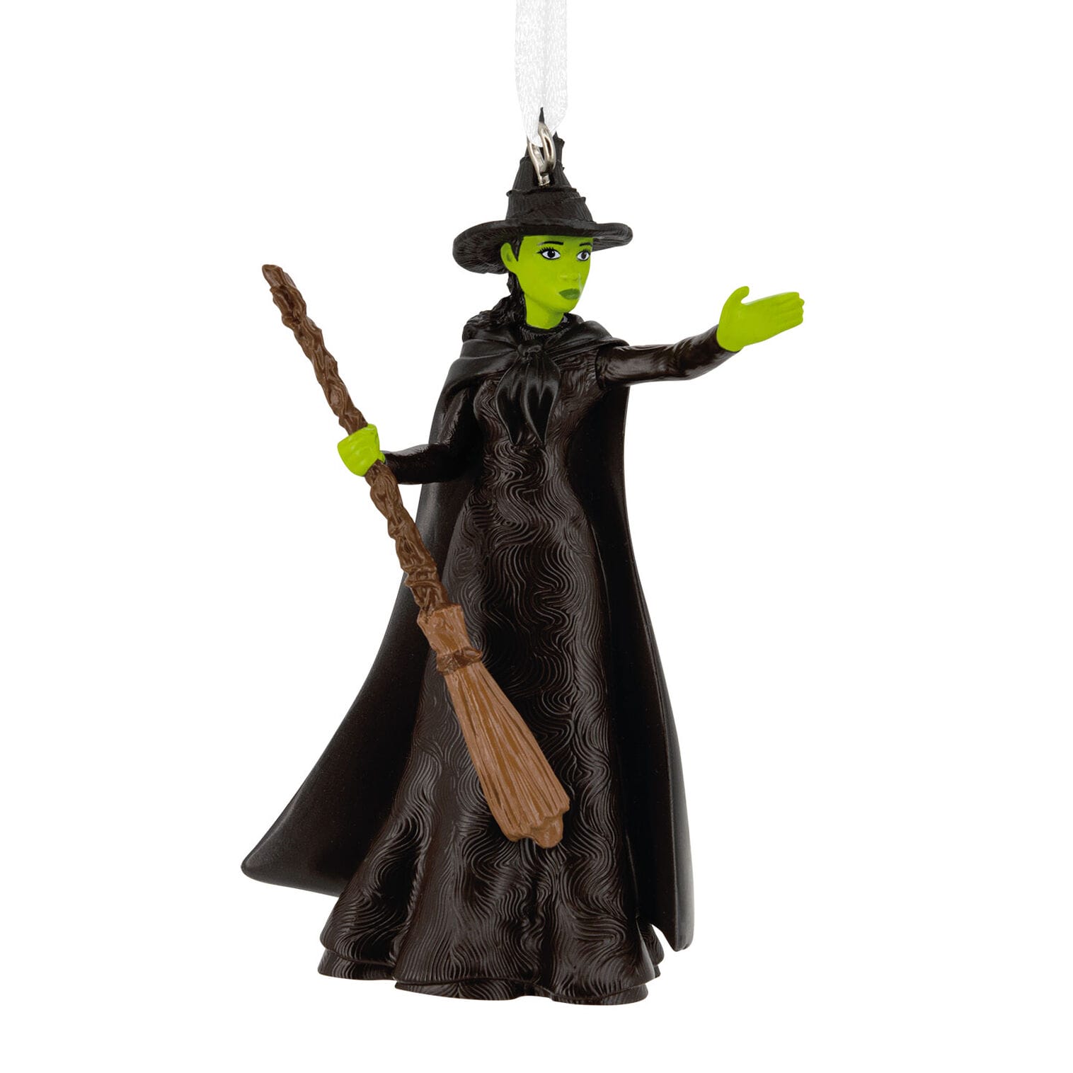 Ornament of a green-skinned witch in classic black dress and hat, broom in hand