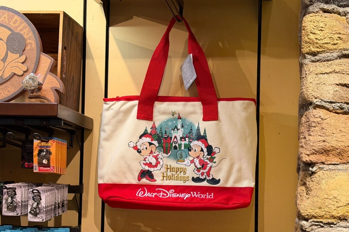 A Walt Disney World tote bag showing Minnie and Mickey in festive outfits, “Happy Holidays,” and park branding—no castle pictured.