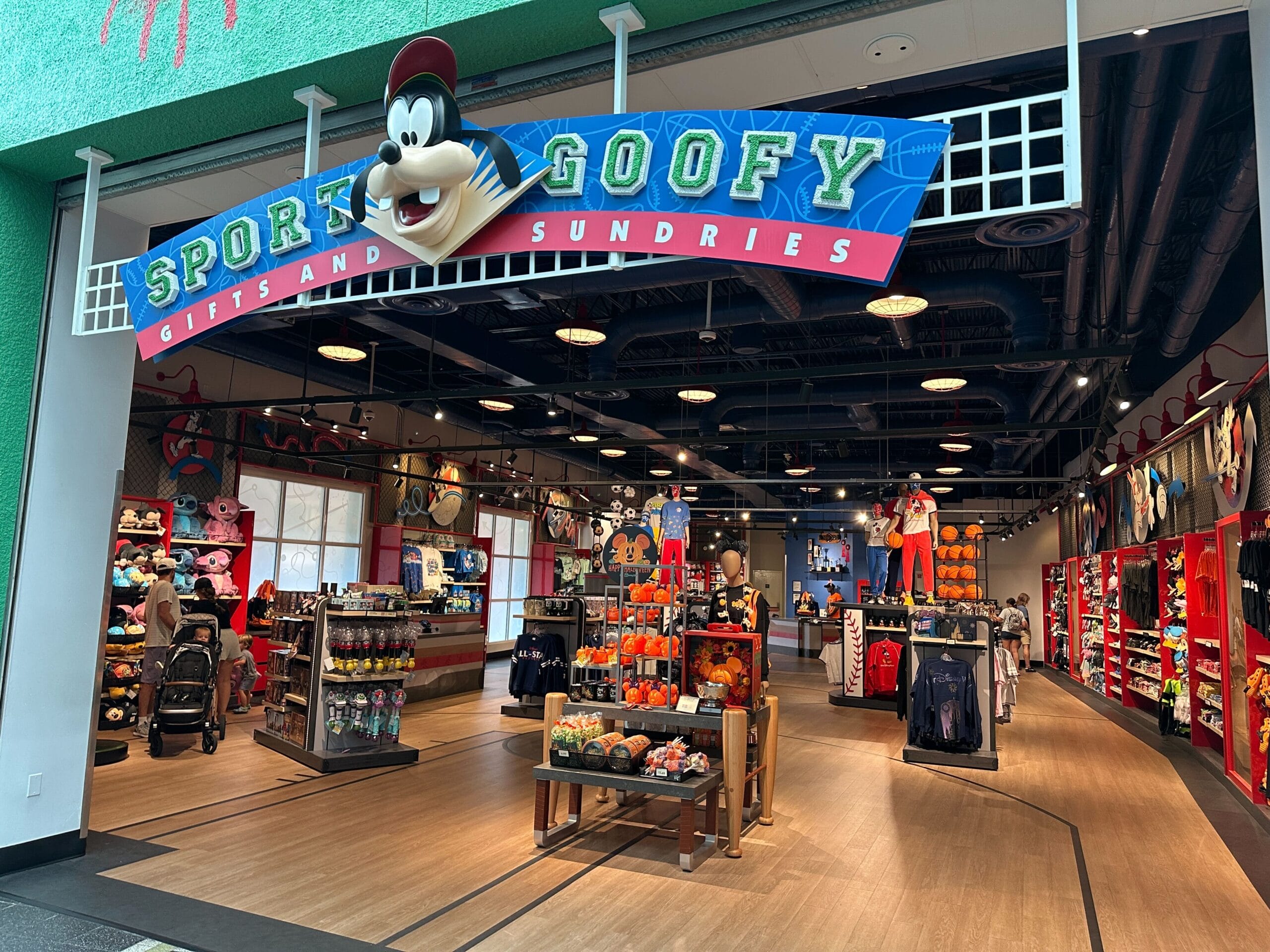 Sport Goofy store at Disney's All-Star Resorts features a Goofy sign, plush toys, magnets, and colorful merchandise inside.