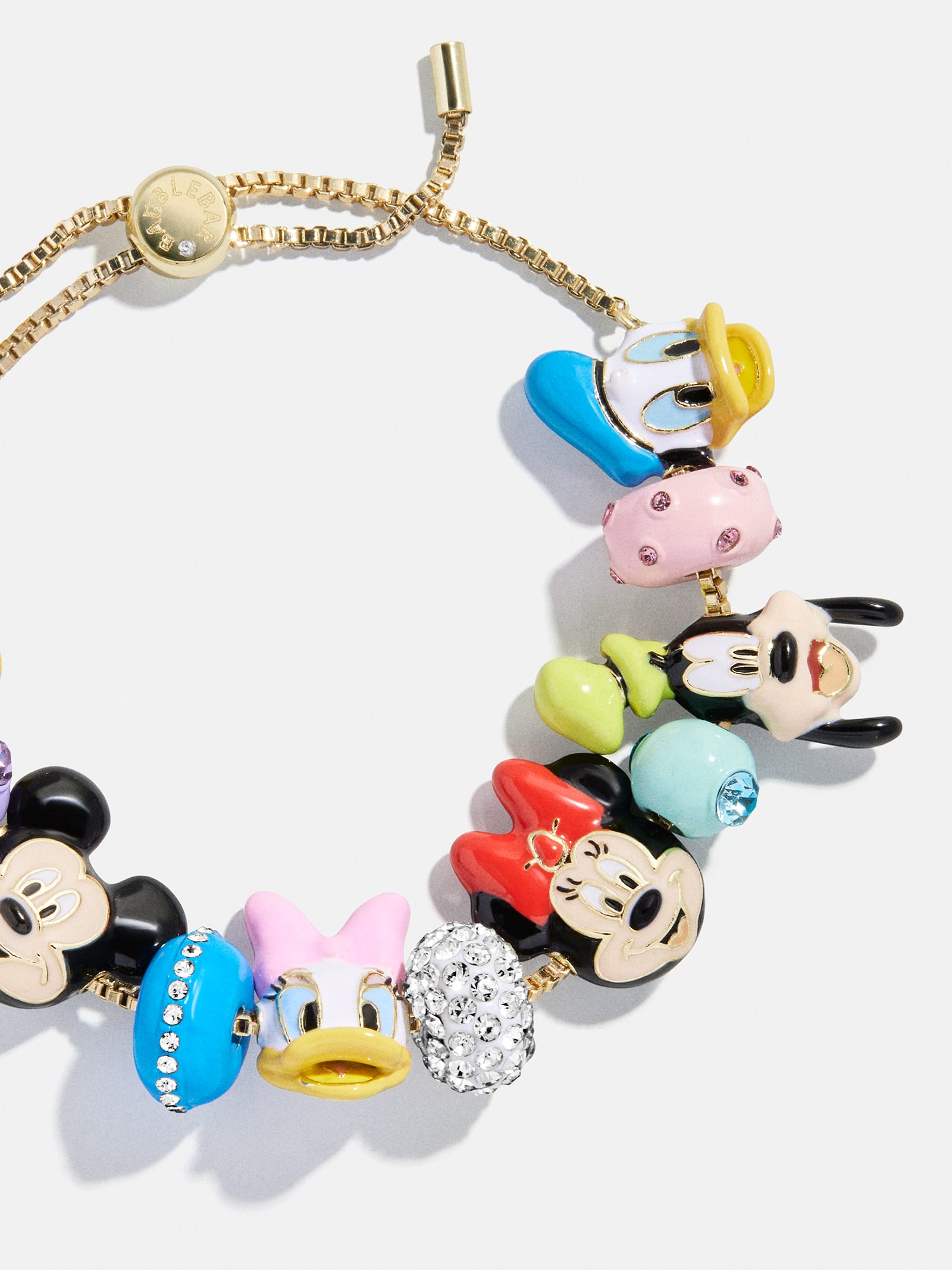 A gold charm bracelet with colorful Disney character charms like Mickey, Minnie, Donald, and Daisy—favorites in all Disney Parks.