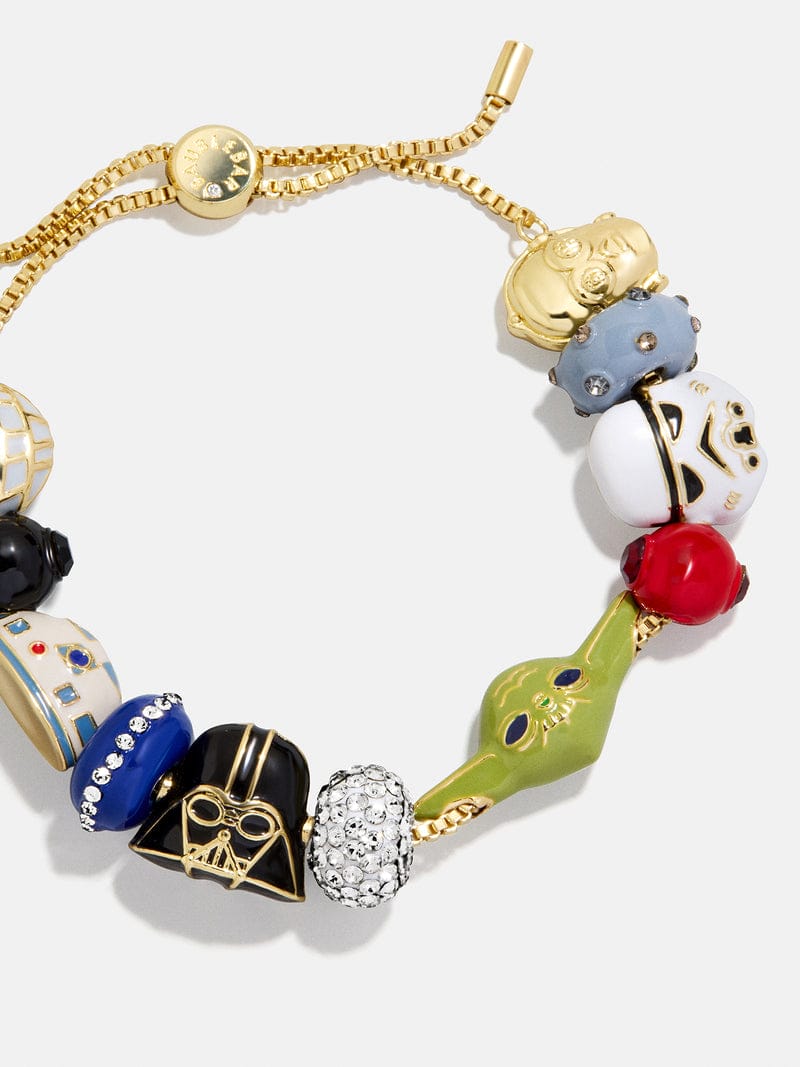 Gold bracelet with colorful Star Wars charms—Darth Vader, Yoda, Stormtrooper, R2-D2—perfect for Disney park fans.