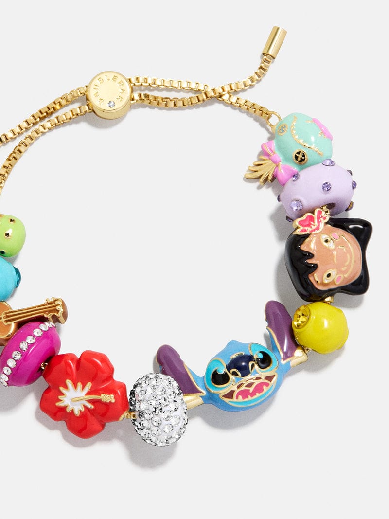 Gold chain bracelet featuring colorful, Disney Parks-inspired beads, like a blue frog, a flower, and a bright yellow accent bead.