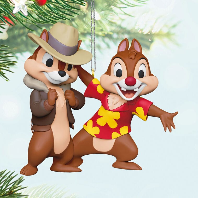 Two chipmunks in holiday attire beside a Christmas tree, reminiscent of Disney Park decor—ideal for Hallmark collectors.