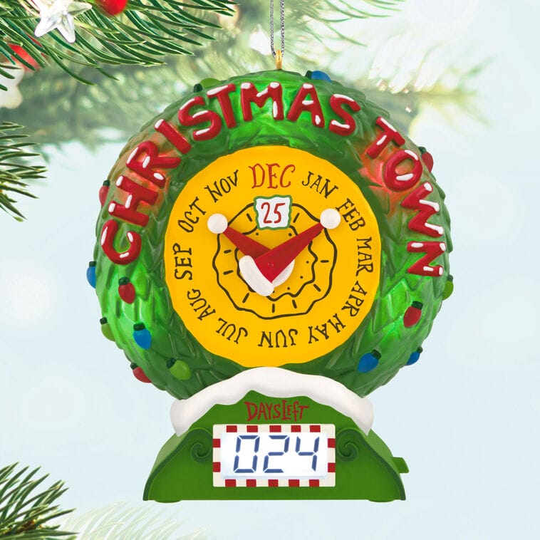 Green Christmas ornament with a calendar clock face and "DAYS LEFT 024," Hallmark-style, hanging on a tree, not Disney castle themed.