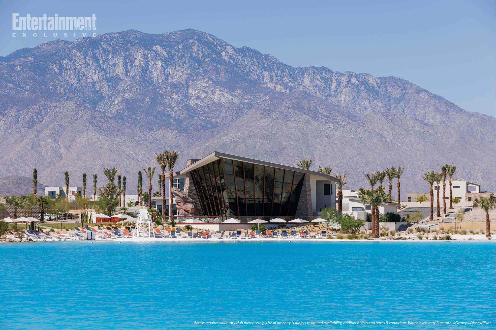 A contemporary resort with a pool, palm trees, and mountains—evoking Disney’s Cotino but without the iconic Disney castle silhouette.