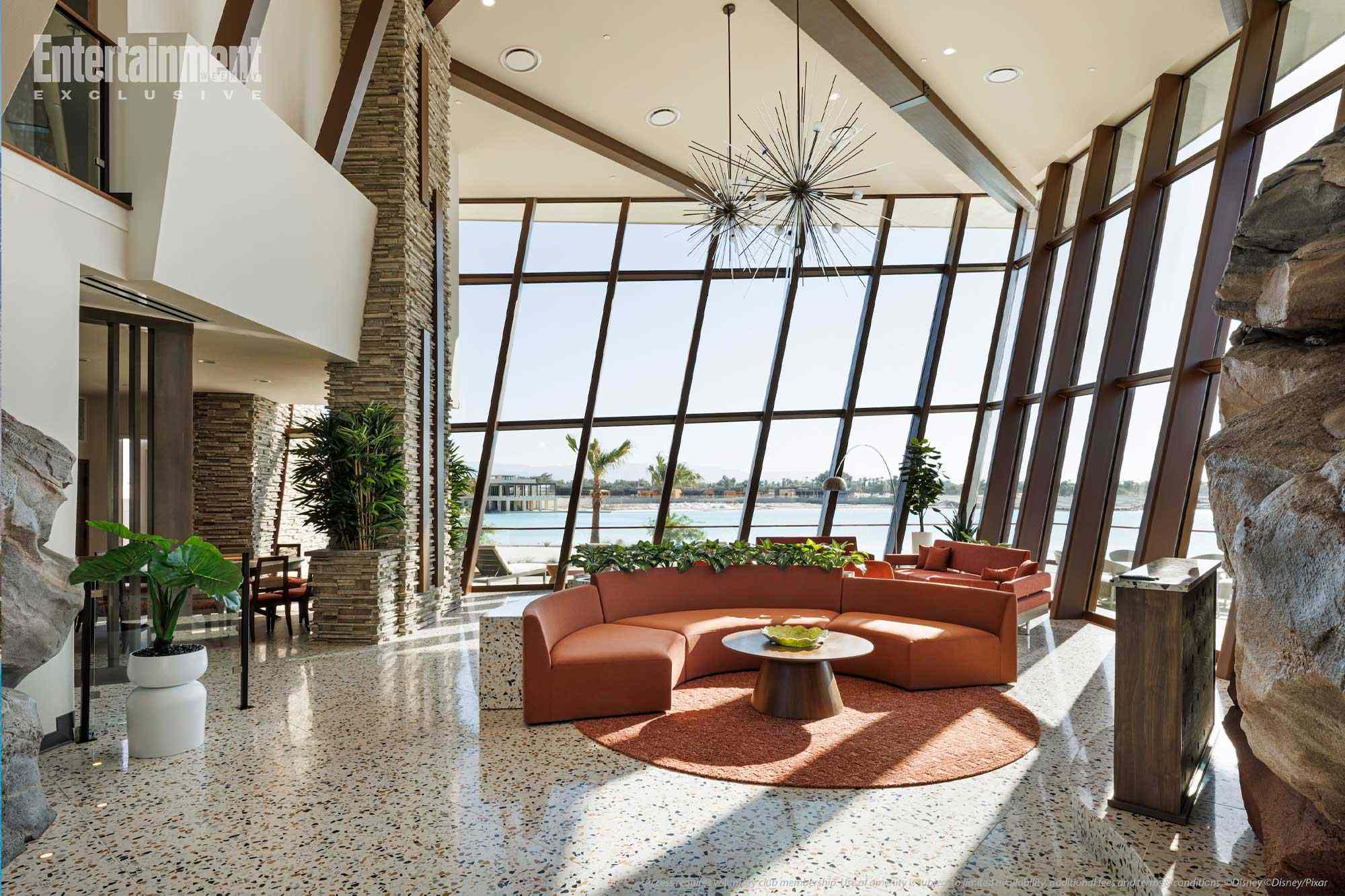 Mid-century modern lounge at MCO Terminal A with orange sofas and sputnik chandelier, not resembling any Disney park castle nearby.