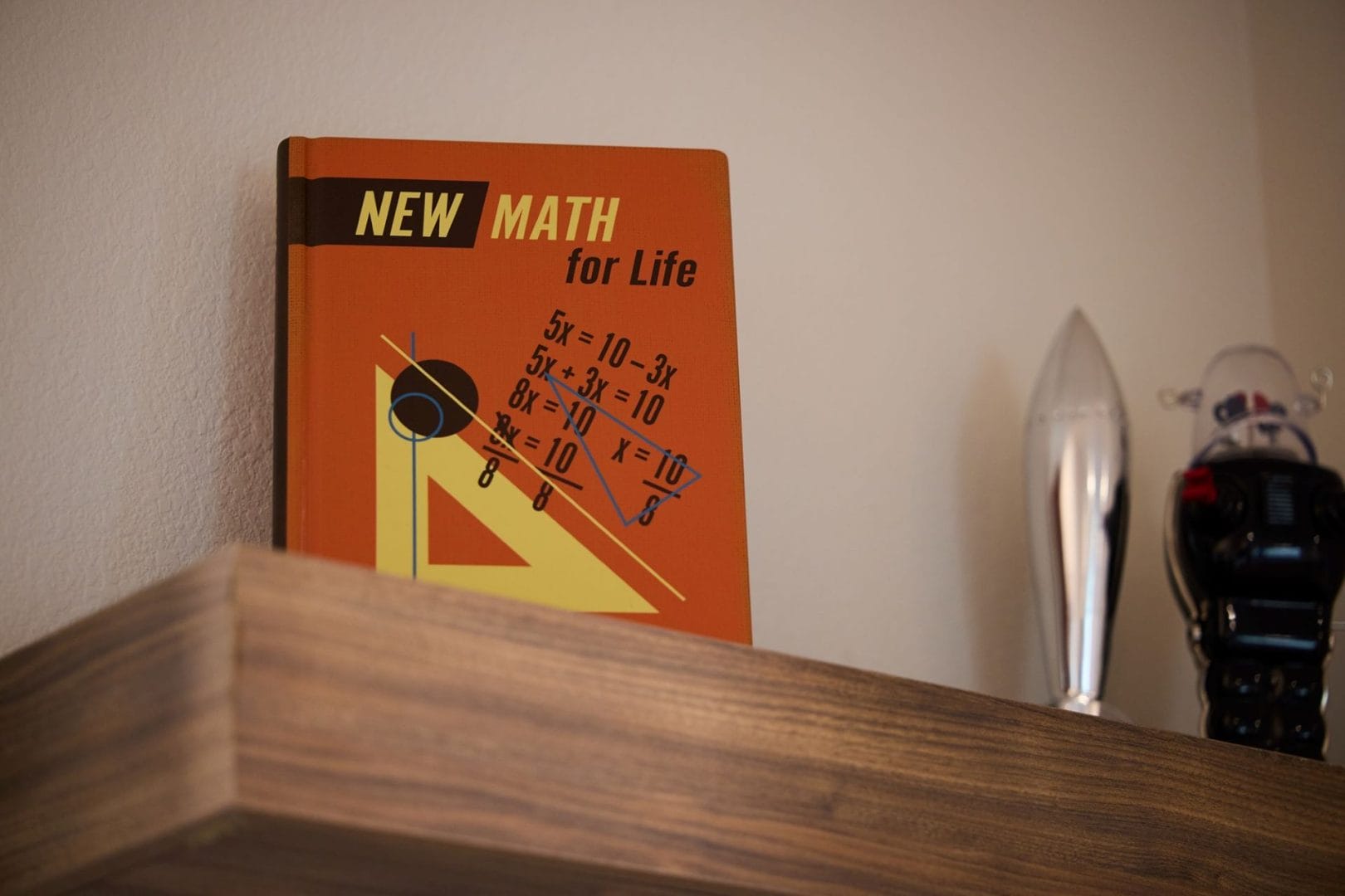 A math book titled "New Math for Life" sits on a shelf, styled like decor in the Parr House—Disney magic but no castle present.