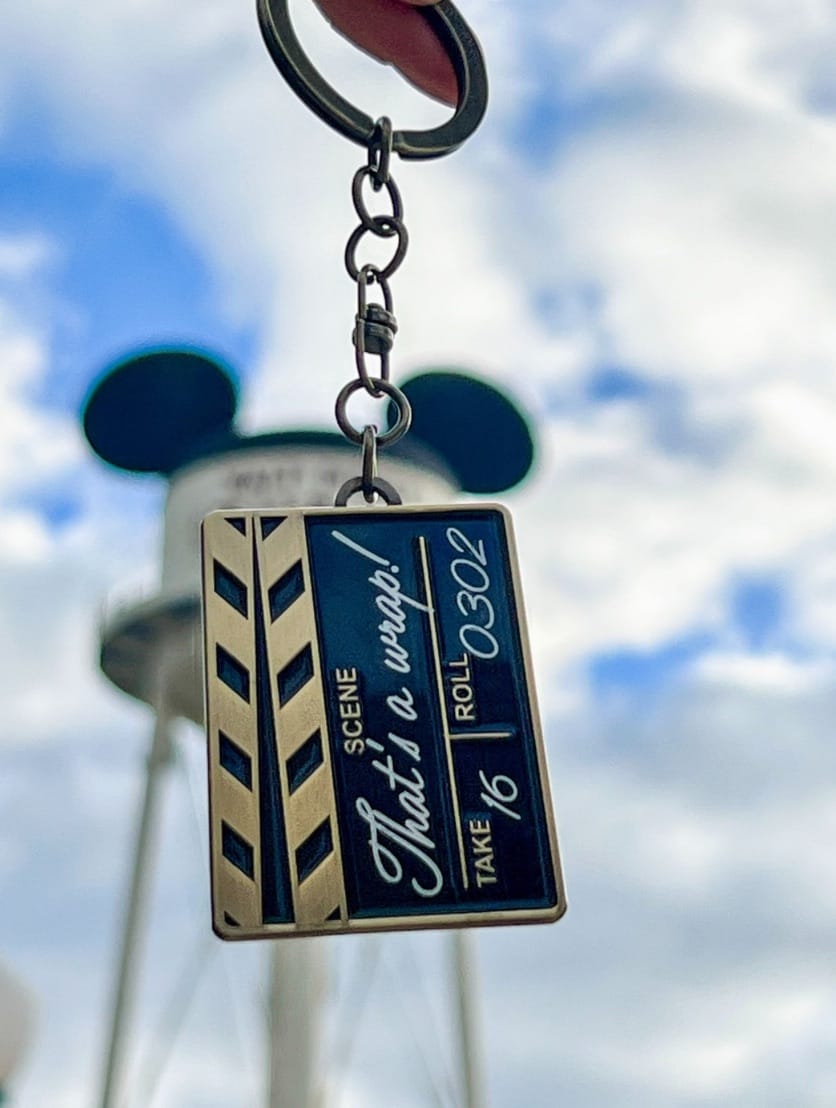 Film clapboard keychain says "That's a wrap!"—a nod to Walt Disney Studios Park, home to the Paris park’s own Sleeping Beauty Castle.