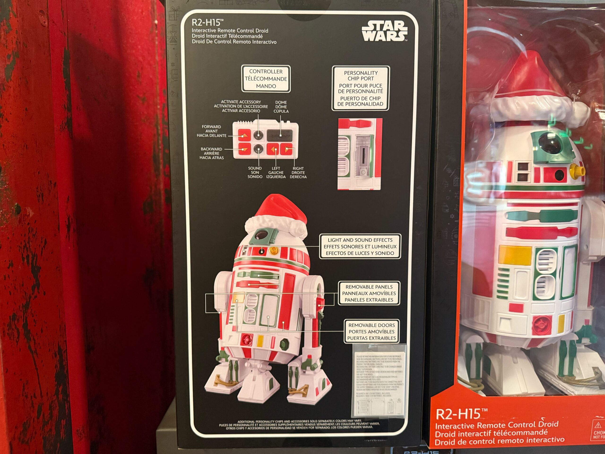 Festive 2025 Disneyland Christmas merchandise box with R2-H15 droid toy in a Santa hat, features and prices listed.