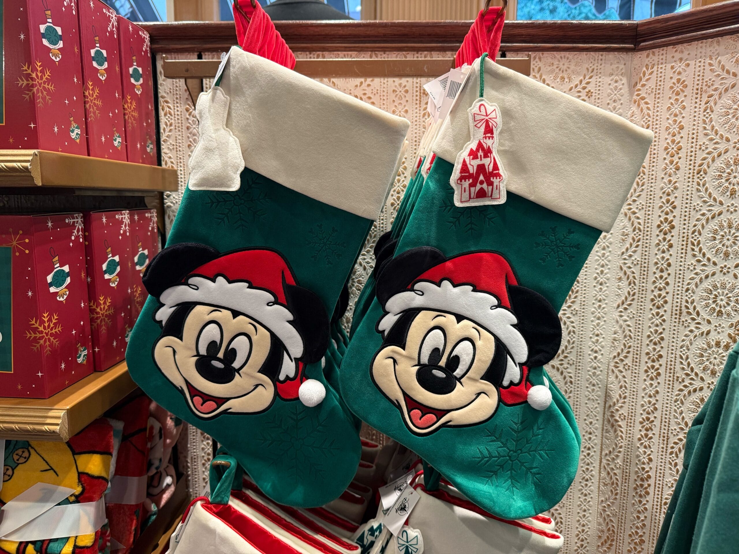 Two green Christmas stockings with Mickey Mouse faces and Santa hats—festive Disneyland Christmas merchandise for 2025.
