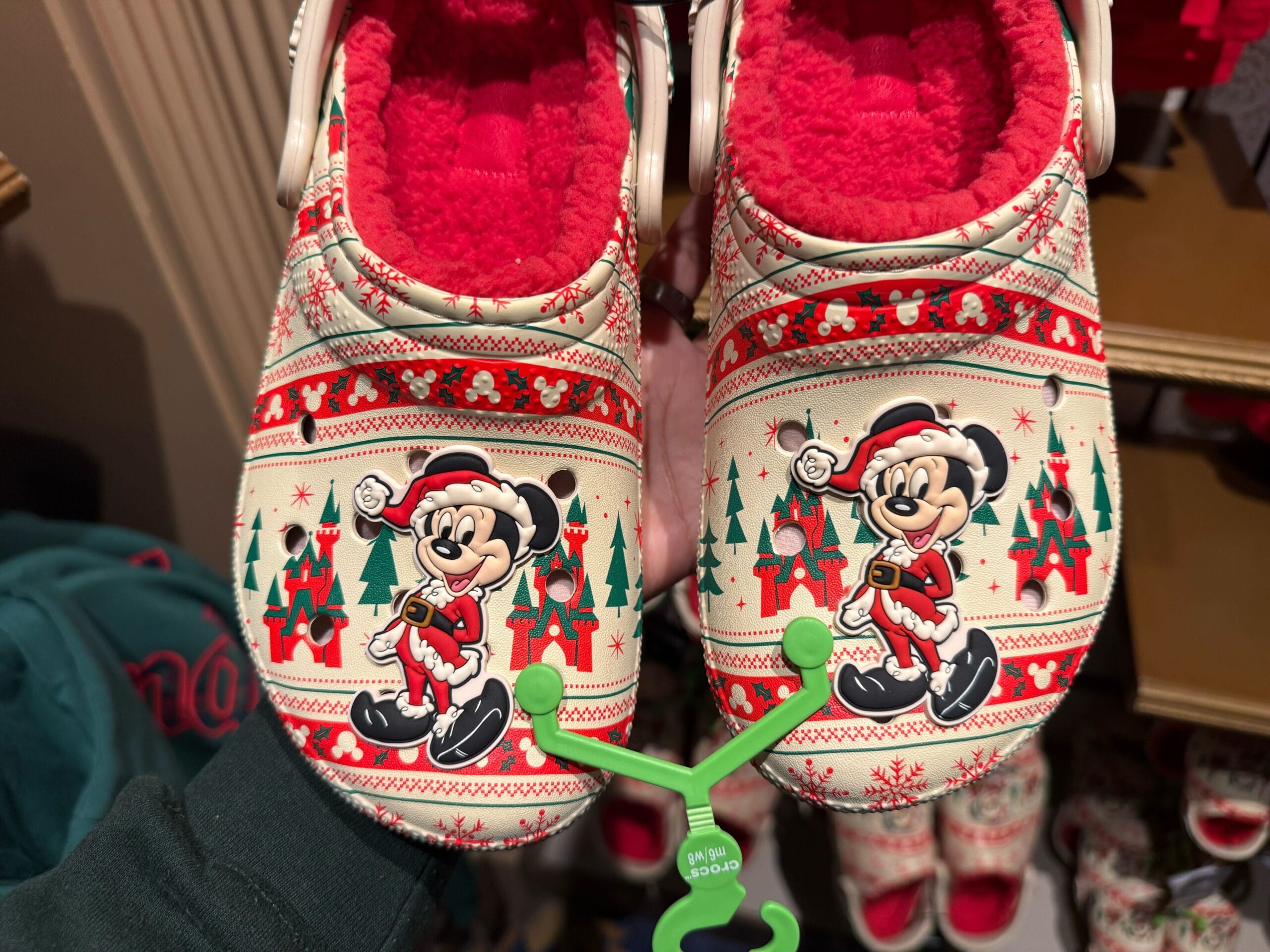 A pair of 2025 holiday-themed slippers featuring Mickey Mouse in a Santa outfit, part of Disneyland Christmas merchandise.