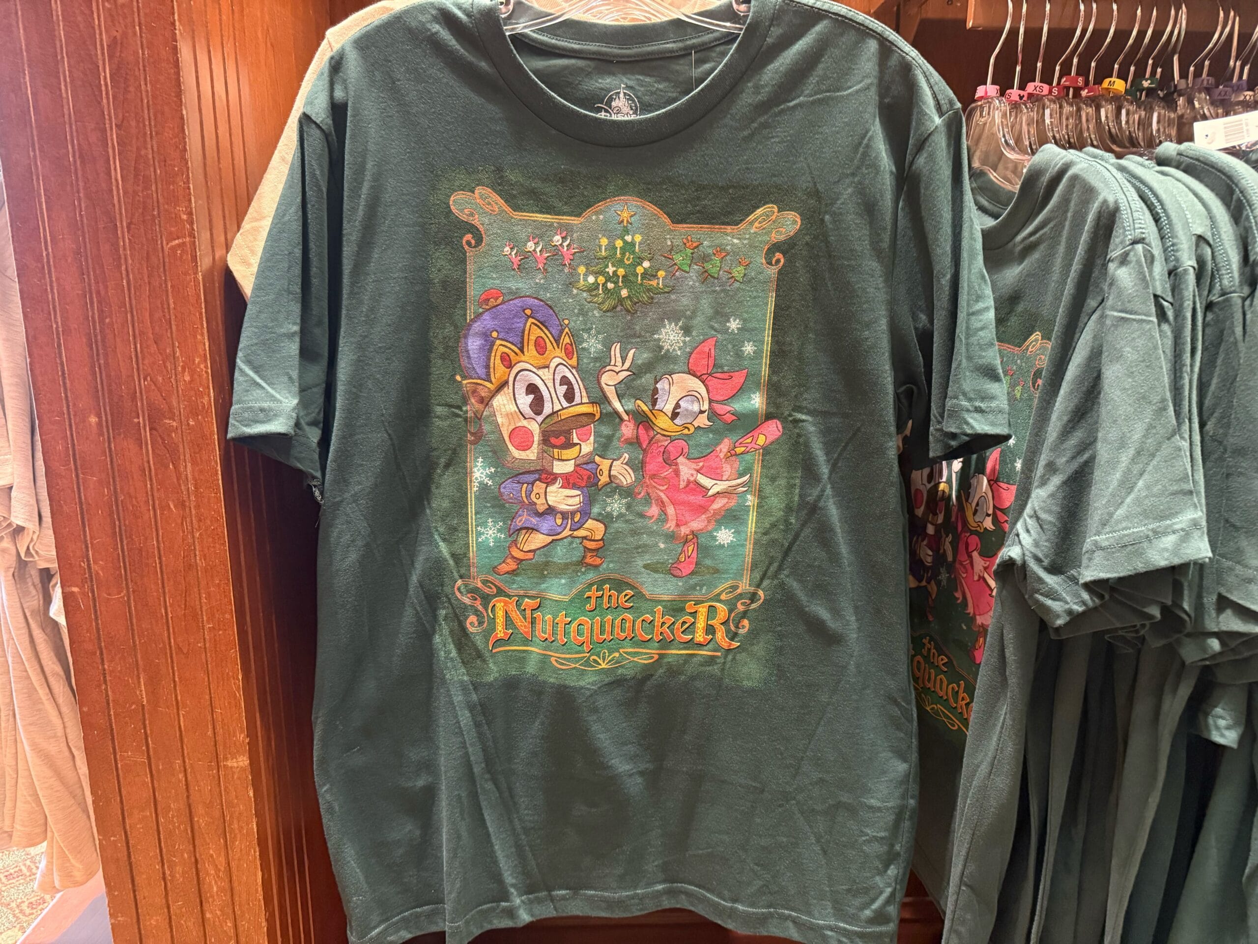 Green T-shirt featuring Disneyland chipmunks as Nutcracker dancers—festive 2025 merch, no castle like Cinderella or Sleeping Beauty.