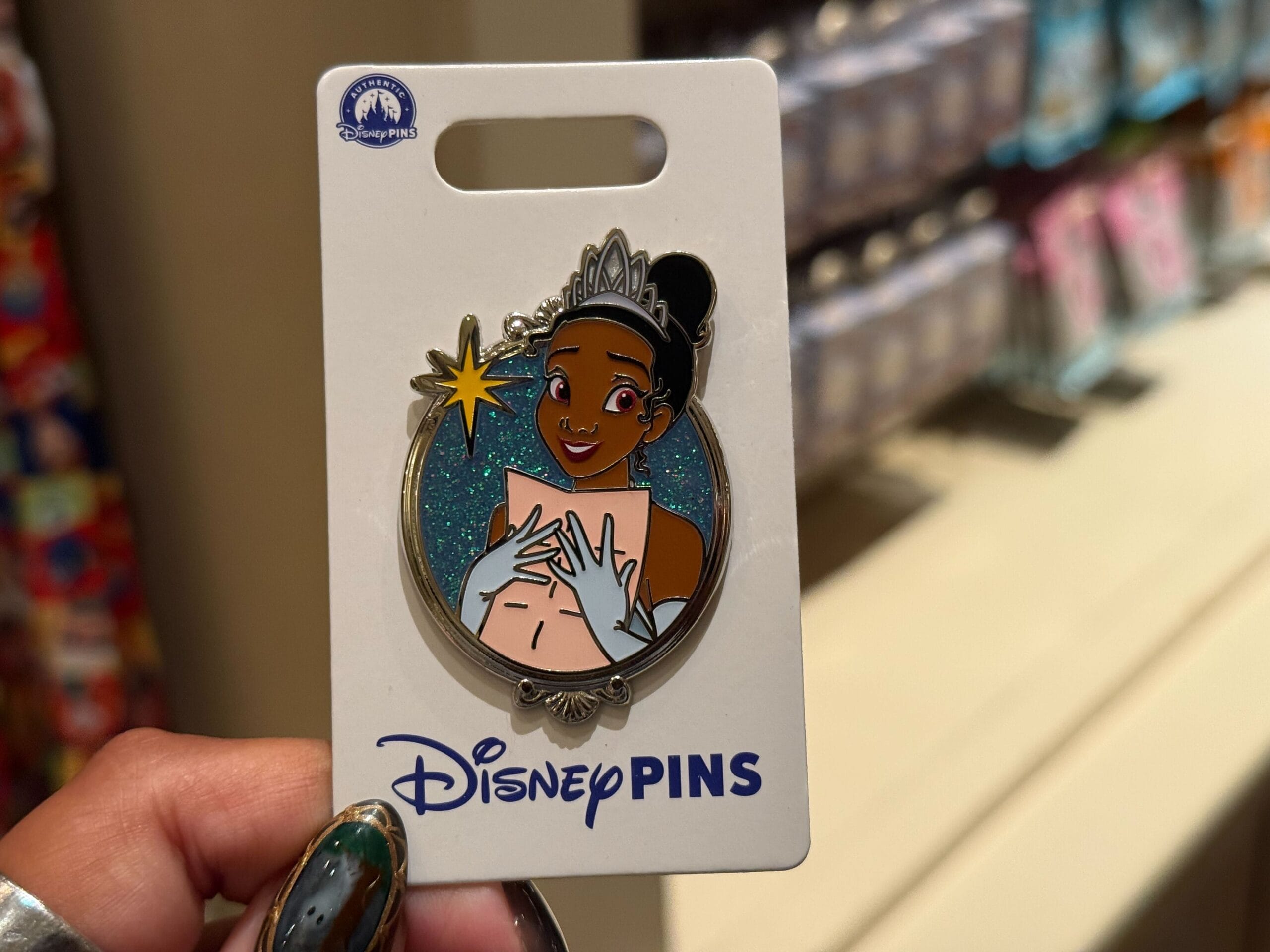 A Disney Princess Pin with Tiana smiling in her tiara and gown, shown on a white "Disney Pins" card from a Disney Park collection.