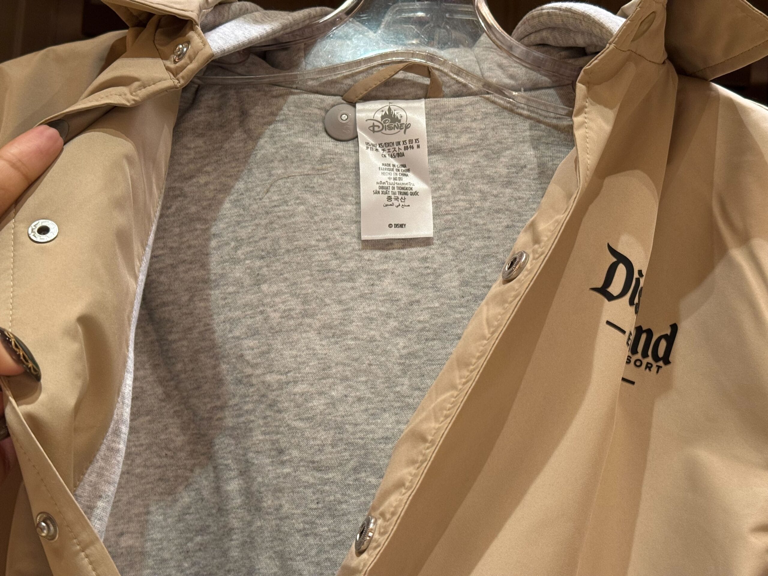 A beige jacket with gray lining and inner tag, sporting a “Diamond” logo—special Disneyland merch, unlike any park’s castle.